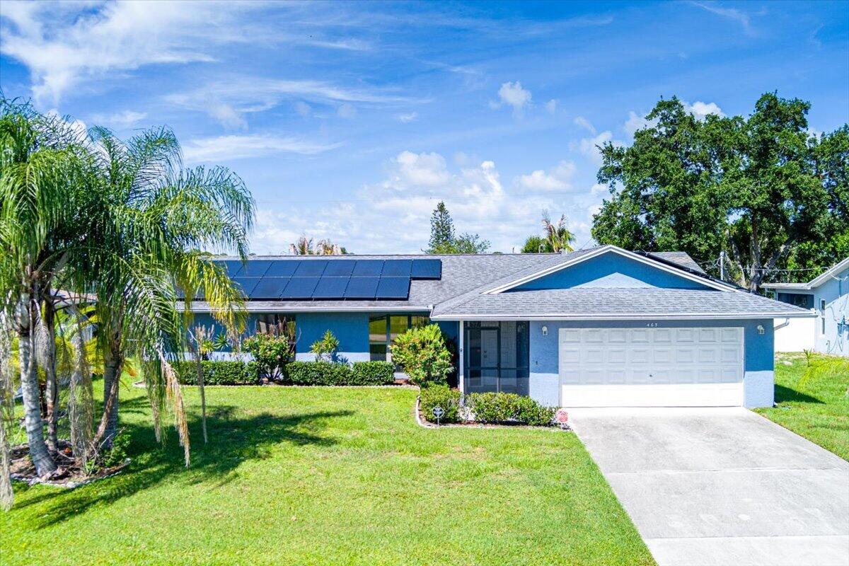 Discover exceptional value at 465 SE Asbury Lane! This well-maintained 3-bedroom, 2-bath home features a desirable split-bedroom floor plan, vaulted ceilings, and spacious living areas filled with natural light. The bright kitchen offers abundant counter space, backyard views, and a convenient pass-through window to the expansive screened lanai—perfect for entertaining year-round. The oversized fenced backyard provides plenty of room for pets, play, or a future pool. Enjoy peace of mind with a solar panel system, whole-house Generac generator, indoor laundry room, and 2-car garage. Ideally located near shopping, dining, parks, schools, and major commuter routes with no HOA.