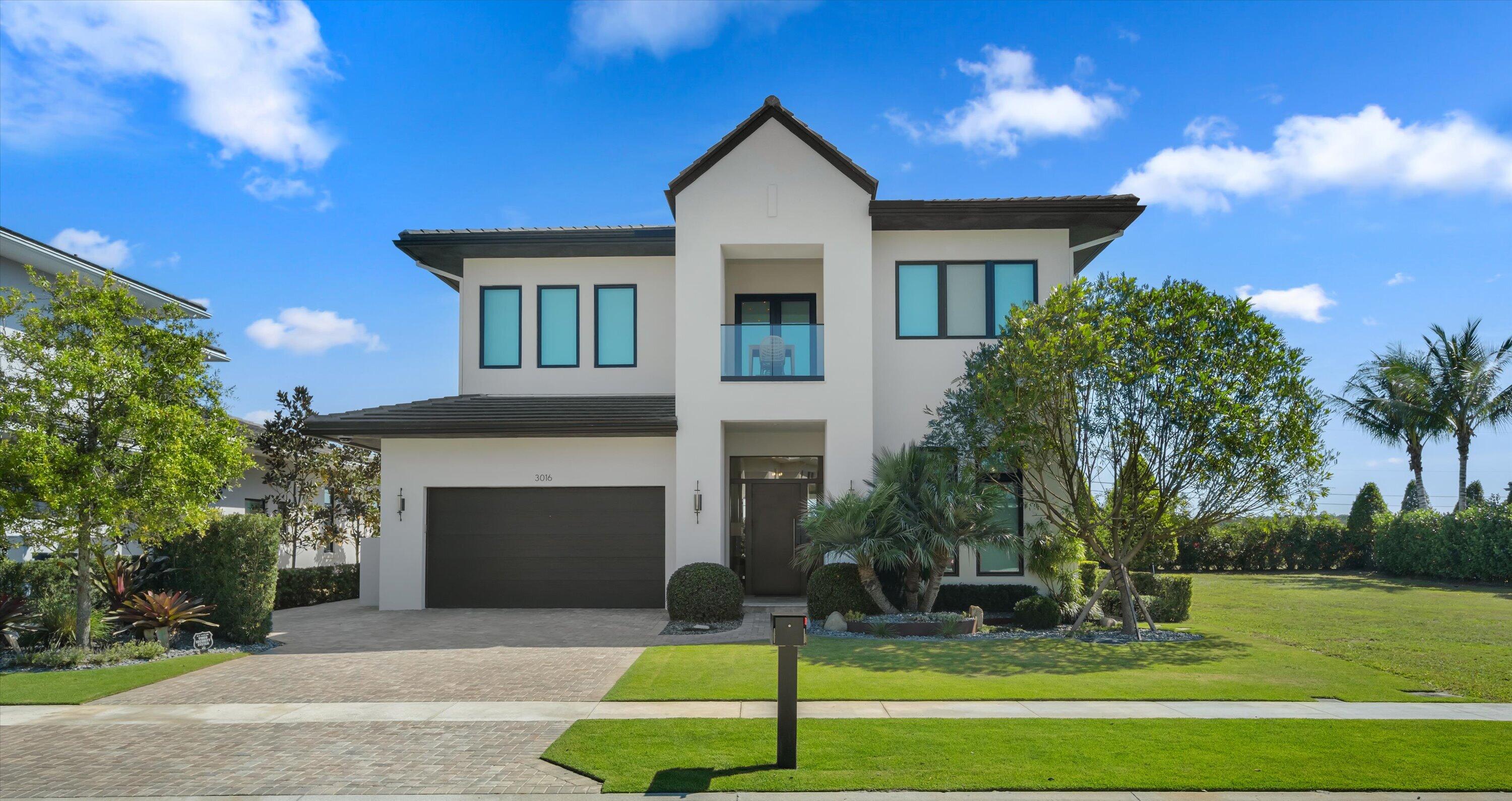 Located in the highly desirable Blue Cypress neighborhood of Palm Beach Polo, this two-story residence offers refined modern living on a rare double lot, including the adjacent parcel for added space, privacy, and future potential. The home features 4 bedrooms, 4 full and 1 half bath, and a 2-car garage. Bright, open interiors are framed by soaring ceilings, warm finishes, and expansive glass, creating a seamless connection between the indoor and outdoor living spaces. The main level includes the primary suite and a guest bedroom that can also function beautifully as an office. Upstairs, two additional bedroom suites, a balcony, and a generous loft provide comfort and flexibility.  Thoughtfully designed for both everyday living and entertaining, the covered outdoor area overlooks a sleek pool and spa and includes a summer kitchen and convenient cabana bath, creating a private setting for relaxing or hosting guests. Set on an exceptional double lot, this property offers a rare combination of style, space, and privacy within one of Palm Beach Polo's most sought-after enclaves.