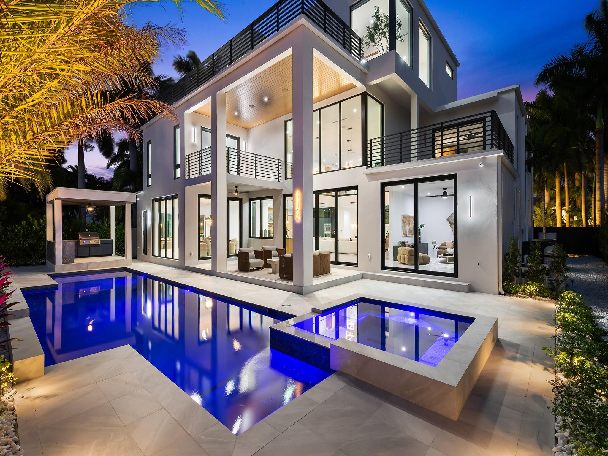 New Construction 2026! Nestled in a prime Fort Lauderdale location, this property is a masterclass in modern luxury and architectural brilliance. Spanning 6,303 square feet with an elevated 8.1-foot foundation, this 6-bedroom, 7.5-bathroom estate is a boater's paradise, boasting an 85-foot dock with direct ocean access and no fixed bridges. Inside, an elevator or the architectural mitered marble staircase connects the impeccably designed levels, leading to a private, third-floor primary sanctuary and an additional second-floor primary suite. The interior is defined by exquisite natural stone and millwork, including Volakas marble floors, striking sawtooth tambour wood accents on the bar and Montoro Dolomite fireplace. A powder room adorned in Calacatta Macchia Vecchia marble. Culinary enthusiasts will thrive in the kitchen, which features custom local oak cabinetry, an oversized quartzite marble counter, a Silgranit sink, and a spacious butler's pantry wrapped in Ocean Blue Quartzite. This same stunning blue stone extends to the outdoor kitchen, which overlooks a heated saline pool with a custom water feature and a full porcelain-tiled cabana bath. Built with meticulous attention to detail, from dual laundry rooms and motorized silver shades to heavy oak-wrapped composite doors, a 4-car garage, and a dramatic Black Basalt stone entry, this estate offers an unparalleled resort-style living experience just minutes from the airport.