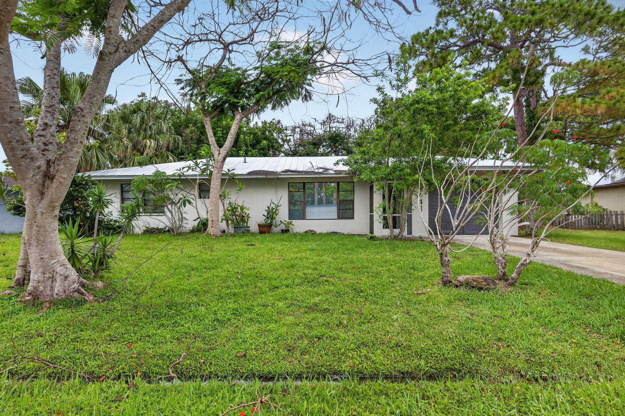 Conveniently located east of Floresta close to the St Lucie River, and community park.  Great opportunity for a first time buyer, or investor with 3 bedrooms, 2 bathrooms, and CBS construction with tile flooring throughout the house.  Metal roof was installed in 2024 for peace of mind.  Large screened porch overlooks private back yard.  Quick access to Crosstown Parkway, i95, and US1.