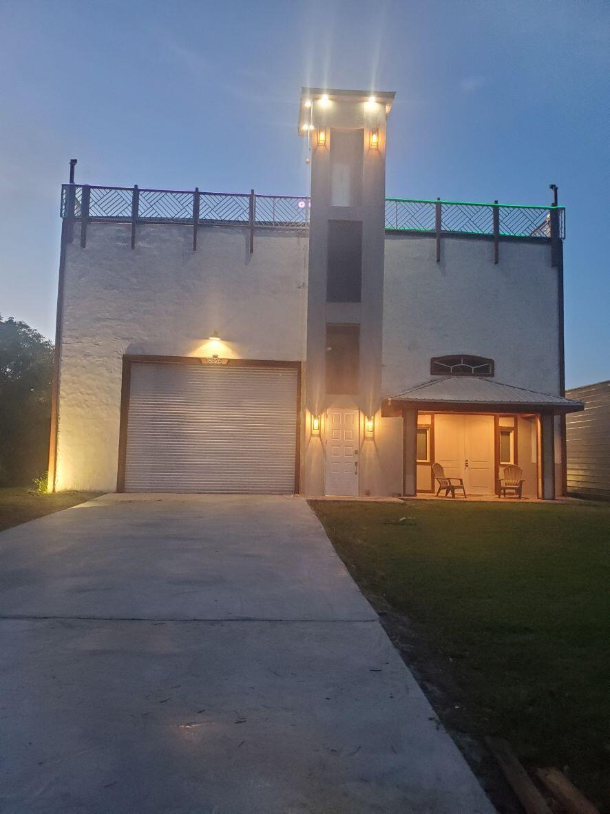 This unique property is being offered strictly AS-IS, allowing the next owner to step in and complete the custom elevator installations according to your personal design and finishing touches.  The third floor has 800 sq. ft. of floor space that has installed plumbing, which offers an incredible opportunity to customize and realize immediate equity.  The elevator tower/shaft is built to code, pre-wired and passed all inspections.  The property features solid construction with impact glass windows.  The first floor of this property is move-in ready.  New kitchen cabinets, granite countertops and appliances, washer and dryer.  The garage is equipped with a 50 gal. compressor with pull-down hose.  The property has 2 steel buildings with finished floors.  Schedule your tour today.