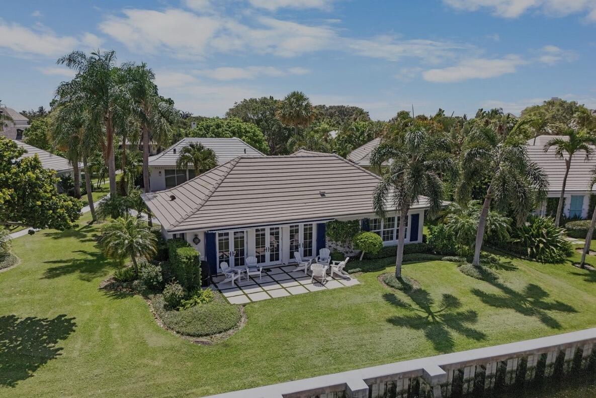 Welcome to this exquisite golf cottage in the exclusive Lost Tree Village of North Palm Beach. Fully rebuilt and beautifully furnished, this waterfront gem offers stunning sunset views over Little Lake Worth, combining coastal elegance with modern comfort. Charming Layout: 2 spacious bedrooms and 2 luxurious bathrooms, perfect for intimate living or entertaining. Spectacular water views from the cottage, showcasing breathtaking sunsets. Modern Design: Rebuilt with an open-concept kitchen and family room, featuring impact French doors for seamless indoor-outdoor living. Elegant Finishes: Marble floors throughout, complemented by high-end furnishings and tasteful decor. This turnkey cottage is a rare opportunity to own a beautifully appointed home.