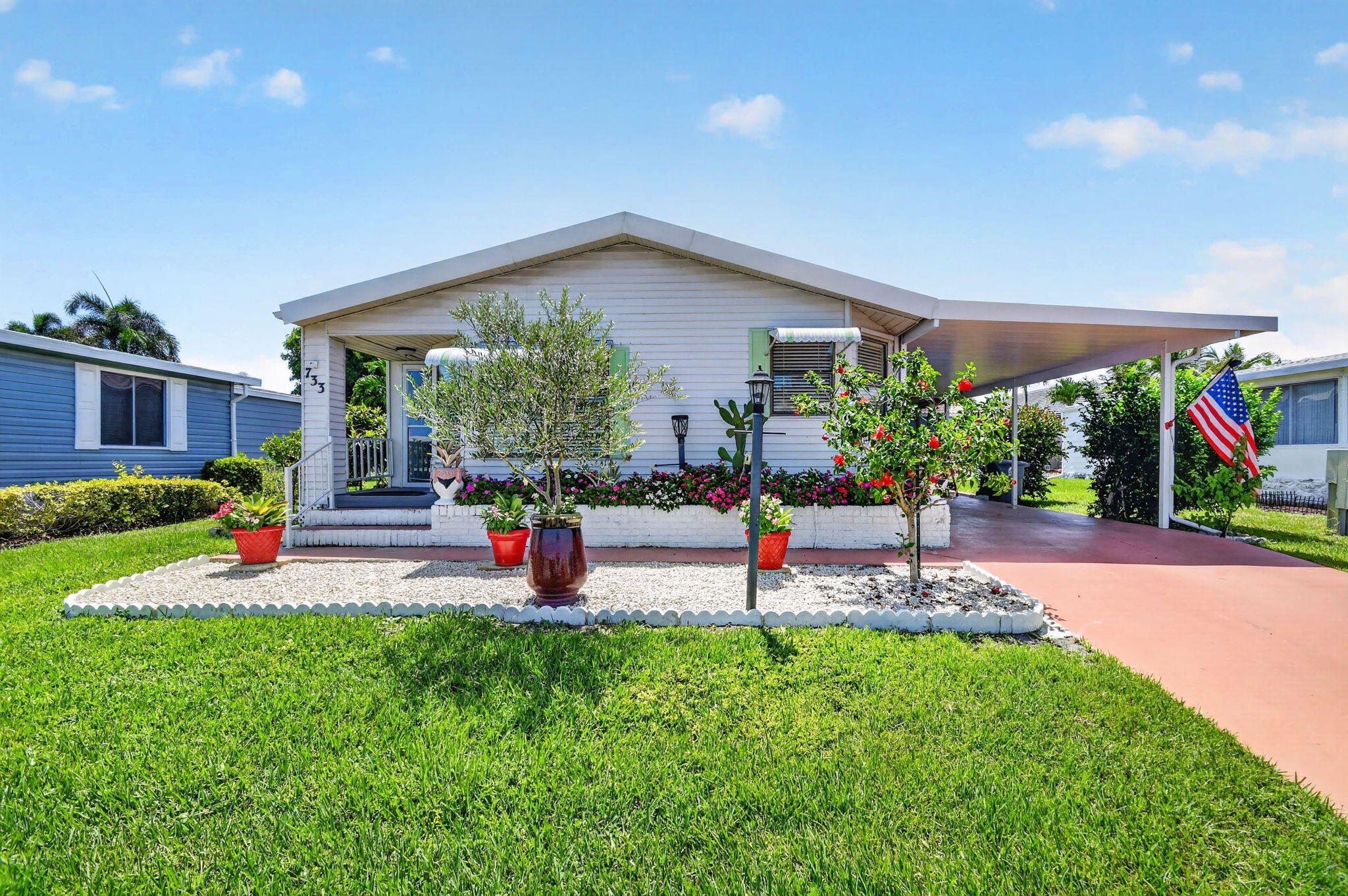Welcome to this beautifully maintained and move-in ready residence in the highly sought-after gated community of Sunny South Estates. Offering 2 bedrooms, 2 bathrooms, and a spacious open-concept floor plan, this home combines comfort, style, and functionality, making it the perfect choice for seasonal or year-round Florida living.  Inside, you'll find soaring ceilings accented with decorative wood beams, a beautifully updated kitchen, Newer appliances, tile backsplash, high-quality cabinetry, and an interior laundry room complete with a washer and dryer. Recent improvements provide added peace of mind, including a 2021 roof, updated electrical panel, newer A/C system, and water heater.  Outside, enjoy an extra-long attached carport with a storage room, a concrete driveway, and a spacious private backyard offering plenty of room to relax or entertain.  Sunny South Estates offers an exceptional lifestyle with resort-style amenities including a clubhouse, swimming pool, whirlpool spa, fitness center, tennis, bocce, shuffleboard, and an active social calendar. Ideally located just minutes from shopping, restaurants, major highways including I-95, beautiful beaches, medical facilities, and everything South Florida has to offer, this home delivers the perfect blend of convenience, value, and lifestyle. Don't miss this incredible opportunity to own a turnkey home in one of Boynton Beach's most desirable manufactured home communities.
