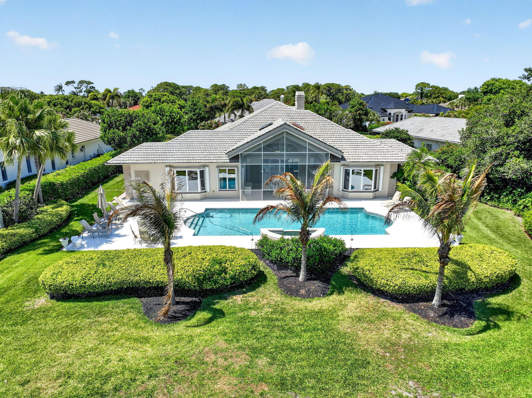 Price Improvement! Located in the exclusive golf community of Mariner Sands Country Club, this beautiful 3,485 square foot home offers 3 bedrooms, 5 bathrooms and breathtaking golf course views! The home is concrete block construction and has a whole-house generator, tankless water heater, and a 3-car garage with epoxy flooring. The kitchen features a gas cooktop, double ovens, Sub-Zero refrigerator, and generous storage, flowing seamlessly into a spacious family room.  The living room with gas fireplace opens effortlessly to a screened lanai overlooking a stunning pool, expansive patio, and sweeping golf course views.  Primary suite is a private sanctuary with dual walk-in closets, double vanities, jacuzzi tub and walk-in shower. Two guest rooms each have  an ensuite bath.  A generously sized bonus room currently used as an office and art studio offers endless possibilities. Perfect as a den, media room, or formal dining space, with ample room to accommodate a pull-out sofa for additional guests. Residents enjoy two championship 18-hole golf courses, Har-Tru tennis courts, pickleball, croquet, and a state-of-the-art fitness center. The community also features a resort-style pool with a separate lap pool, along with the Sand Bar offering exceptional indoor and outdoor casual dining. The spectacular new clubhouse provides both fine and casual dining, along with weekly social events and happy hours. Additional amenities include a dog park, playground, spa, and nail salon—all just minutes from pristine beaches and charming downtown Stuart. Social membership is required with a one-time capital contribution of $50,000 due at closing. Golf membership is separate and optional.