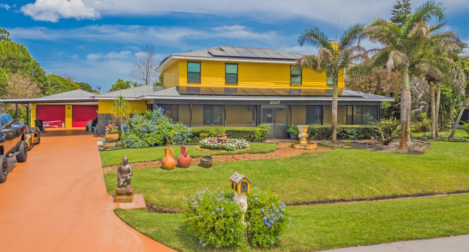 Location! Location! Location! Fantastic Opportunity To Live In The Much Sought After Sandpiper Bay Community! NO HOA! PARK YOUR BOAT, RV & TRAILER!  With Over 3,000 Square Feet Under Air This 2 Story Home With Wraparound Porch Features 4 Large Bedrooms w/Walk-in Closets, 3 Full Baths, Fomal Livingroom w/Wood Burning Fireplace, Large Family Room w/100" Wall Mounted TV, Enjoy Year-round Outdoor Living With Screened-in Pool, Built-in Grill & Tropical Tiki Bar Perfect For Entertaining Family & Friends, Detached Two Car Garage, 2022 COMPLETE IMPACT GLASS, Two 2024 A/C Units, Two 2023 Tankless Hot Water Heaters, Sprinklers on Well, Pulic Water/Public Sewer. Sandpiper Bay Is Home To The Port District On The North Fork of The Saint Lucie River W/River Walk, Canoe/Kayak Launch.