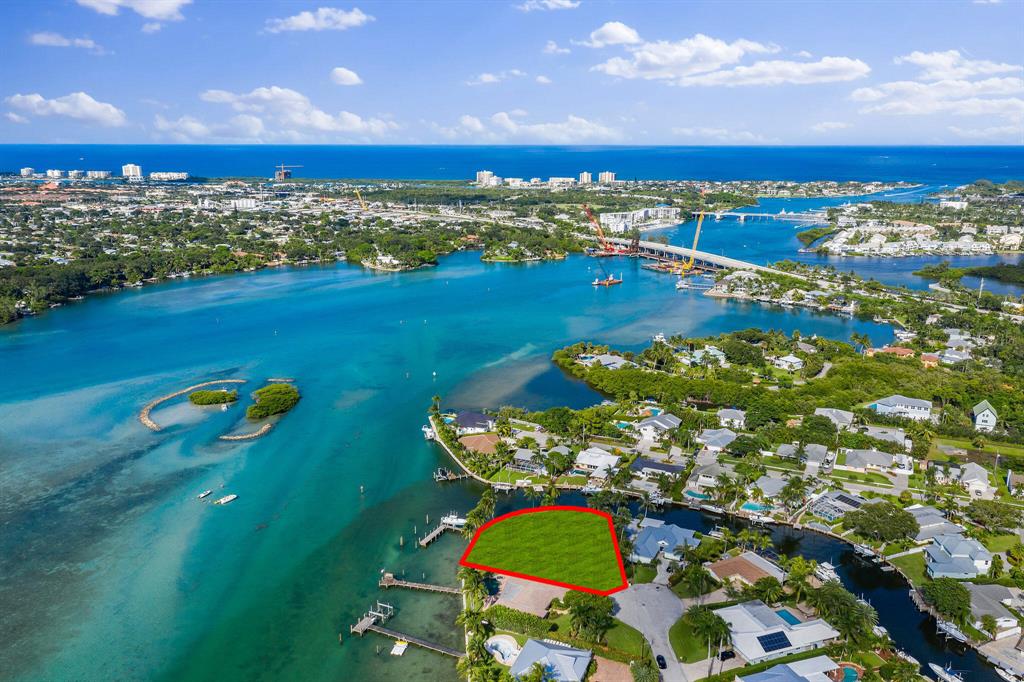 Spectacular cleared lot on the Bahama blue water ready for someone's dream house.   With 232' of waterfrontage just under half acre and a newly installed seawall in 2020.  Also comes fitted with a 12k lbs lift and mature palm trees along property line.   Adjacent home to the south is available also and both properties combined would have 0.75 acres and 407ft waterfrontage!!