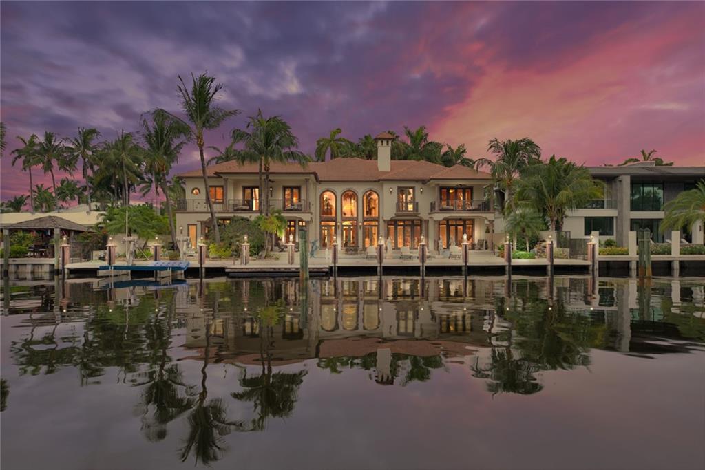 Spectacular estate encompassing nearly 8,000 sq. ft. 120' of DEEP WATER dockage on wide canal, boat lift, tiled concrete dock. Las Olas' best isle & waterway, underground utilities. Impeccable craftsmanship - Venetian Plaster, custom paint/moldings, gold leaf accents, coffered ceilings, inlaid marble floors. Stately 2 story fireplace in living room w/floor to ceiling windows. Exquisite chandeliers & frescoes/custom lighting and vaulted ceilings throughout. Beautiful master w/ His & Her baths/closets plus enormous bonus closet off master, oversized balconies. VIP guest suites w/ balconies. Expansive fully equipped chef's kitchen. 3 car garage, office, custom pool w/ spa, backyard garden and pond. This unique offering is pristine in every way & a pleasure to show!