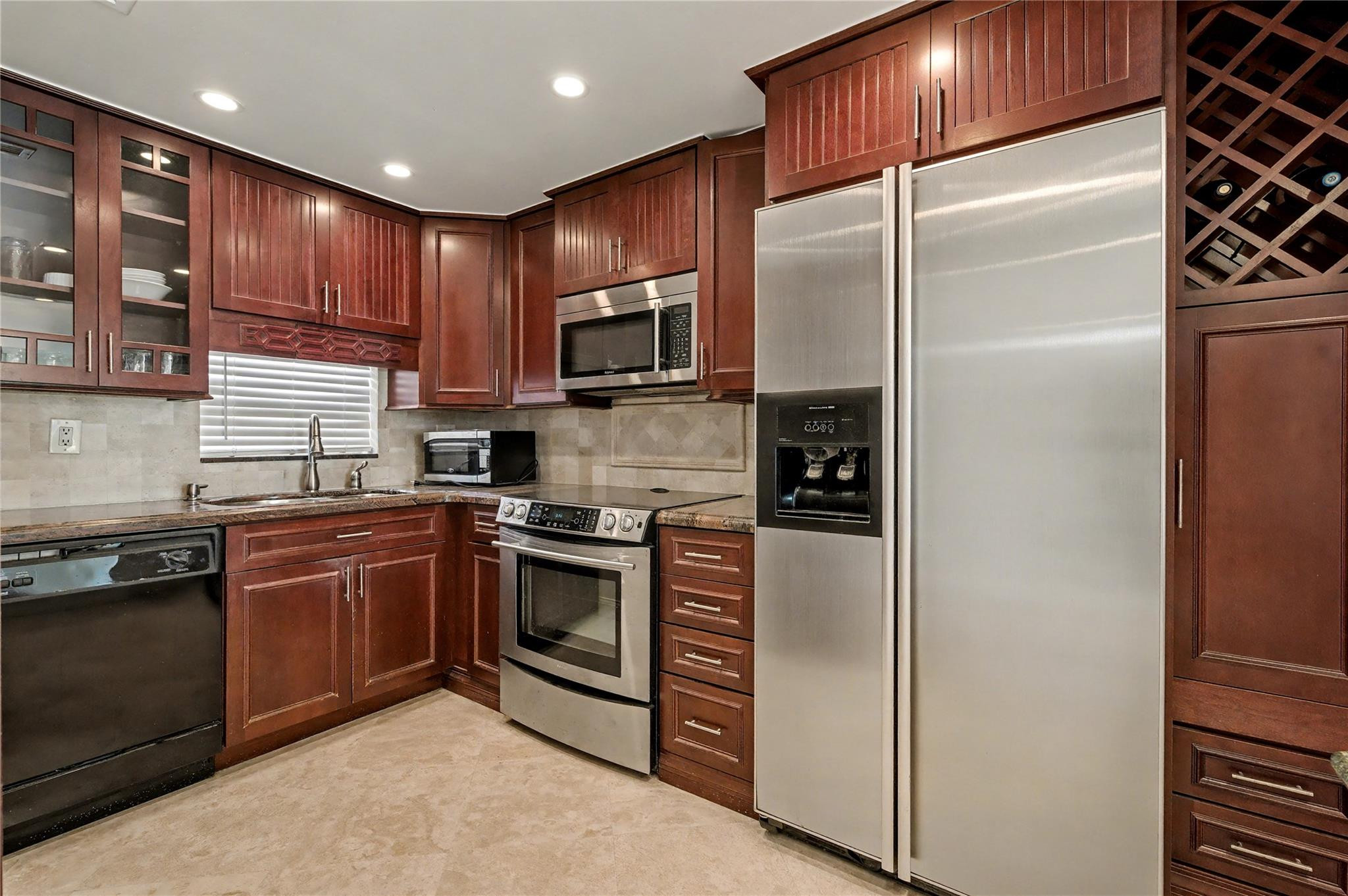 GOLFER'S DELIGHT! 1ST FLOOR BEAUTIFUL PGA GOLF (PGA 16th Fairway) & WATER VIEWS! 2BR/2BA features TRAVERTINE FLOORING THROUGHOUT except Master Bedroom w/high-grade vinyl plank flooring. Exquisite kitchen w/ rich cherrywood cabinetry, granite counters, tiled backsplash, open kitchen w/ large snack counter & 2 large pantries. Crown Molding. AMAZING UPGRADED BATHROOMS W/ DESIGNER VANITIES & SINKS. FREE golf (except cart fees) on two 18 hole courses (PGA & Par3); Amenities include Restaurant, Billiard Room, BBQ/Picnic Area, Clubhouse, Courtesy Bus, Exercise Room, Heated Pool, Library, Putting Green, Sauna, Shuffleboard, Tennis, Pickle Ball, Vehicle Wash Area, Electric Car Charging Station. Close to shops, dining & highways. Association says 55+ age required; ENJOY FIRST CLASS BEAUTY!