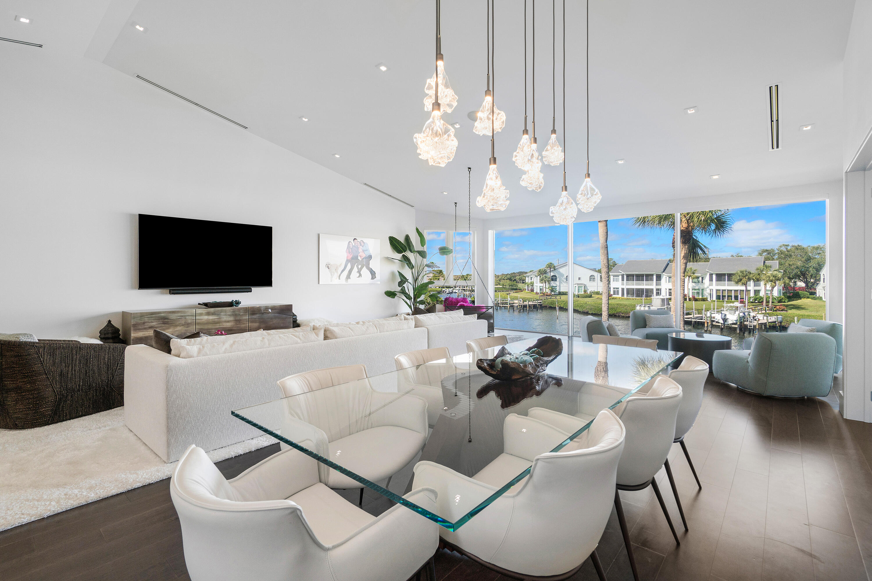 Stunning, fully renovated Harbor Home on a prime point lot in Jupiter's prestigious gated Admirals Cove.  Steps from the main clubhouse to enjoy, marina café, spa, pool, tennis, pickleball, golf, and more.. This home features 3 bedrooms, 3.5 baths, soaring ceilings, floor-to-ceiling La Finestra windows with breathtaking water views. The chef's kitchen boasts Taj Mahal quartzite countertops, Thermador and Fisher & Paykel appliances, and a wine cooler. The luxurious primary suite offers a Japanese soaking tub, dual sinks, oversized walk-in closet with stunning views. Additional highlights include high-end hardwood flooring, elevator, impact windows, electric shades, 3-zone AC, and private boat slip w/ lift. Move-in ready to enjoy the ultimate lifestyle in one of Jupiter's top locations. Required golf membership purchase conveys all the first class amenities of Admirals Cove including two spectacular clubhouses, 45 holes of golf, 5 restaurants, 58 slip marina with floating docks, Yacht Club, 9 har tru tennis courts, 12 pickleball courts, state of the art fitness and wellness center with Technogym machines, 21,000 sq ft spa & salon, 30 room Waterside Private Boutique Hotel for members and their guests, brand new Golf Learning Center, Covesters kids club, dog park and Platinum service. Close to Palm Beach Airport.