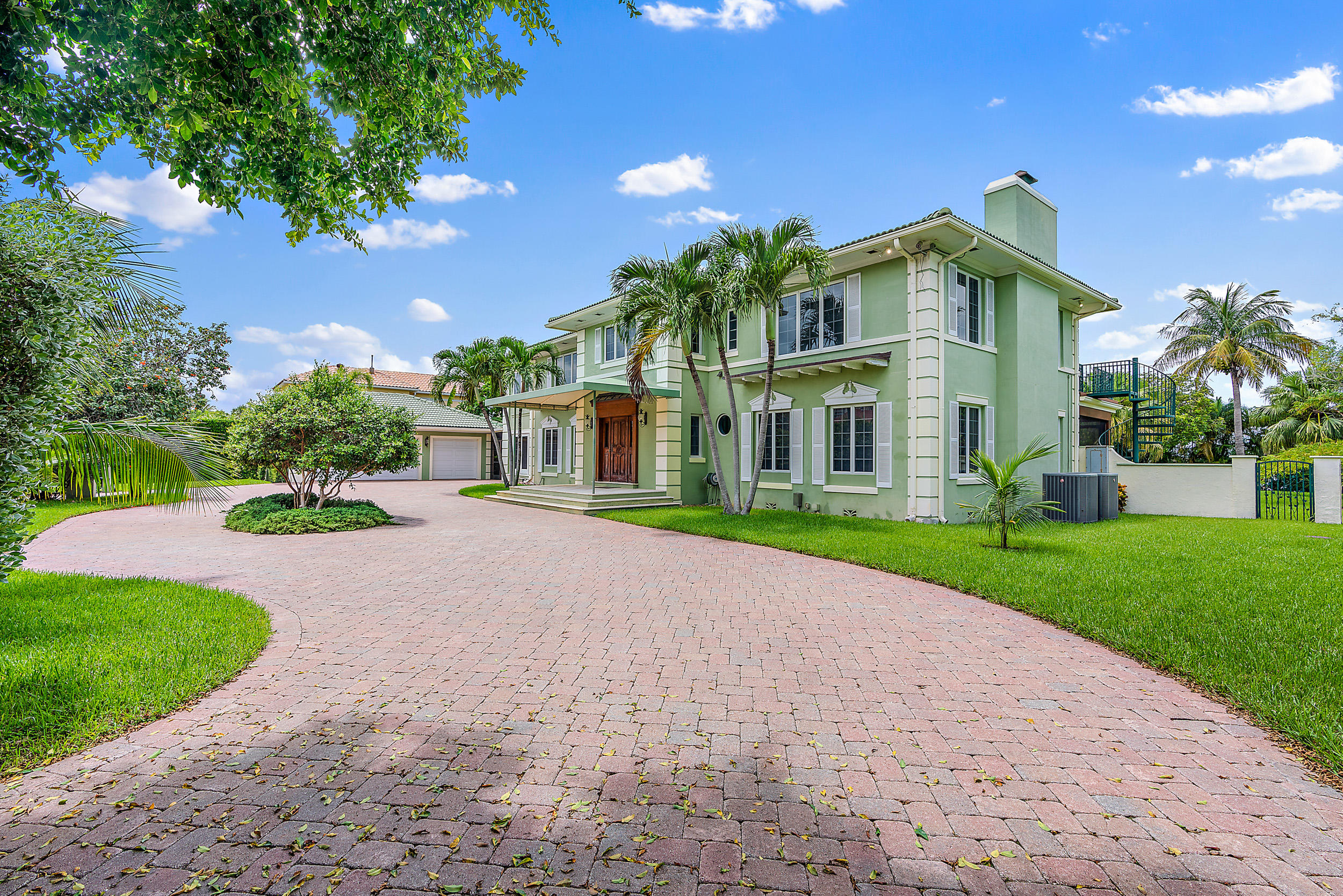 Secluded waterfront estate home on Singer Island with expansive intracoastal views and deep-water access.  This unique property on a 3/4-acre lot has a 140 ft protected dock with four boat slips just minutes away from the Palm Beach inlet.  Lush, mature landscaping surrounds a stone-decked 40 ft pool and generous open backyard perfect for entertaining. 
The 3 bedroom, 4½ bath gated home is completely hidden by stately hedges and features a separate 3 car climate controlled garage and circular drive with plenty of guest parking. A well-appointed 2 bedroom, 2 bath guest house feels like a tropical getaway with a private waterfront patio.
Minutes from 95 and PBIA, this boater's paradise could serve as your launching point for excursions to the Bahamas or other Atlantic Ocean destinations.