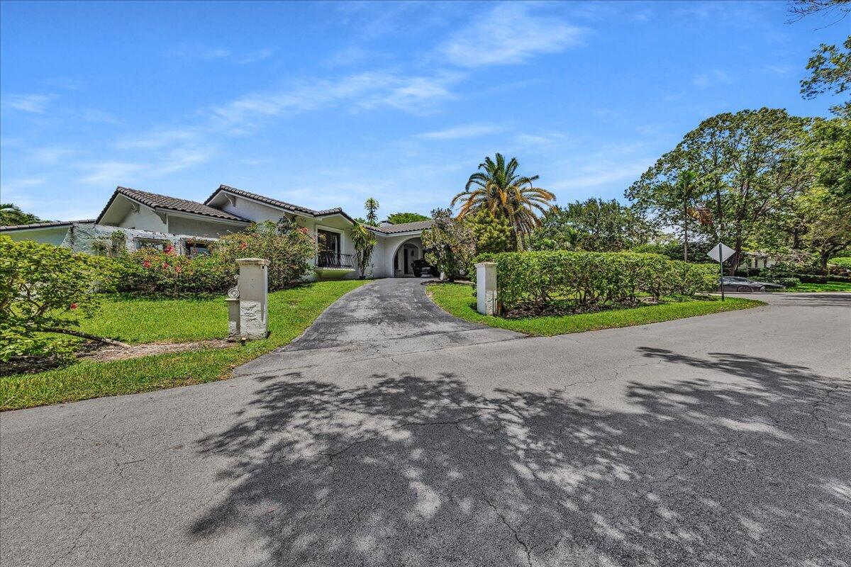 Welcome to a rare lakefront estate in the exclusive, guard-gated community of Pinecrest by the Sea. Set on an approximately 30,000-square-foot corner lot, this updated 6-bedroom, 5-bath residence offers over 4,000 square feet of versatile living space. The 4-bedroom, 3-bath main home features vaulted ceilings, limestone floors, a two-sided coral-rock wood-burning fireplace, quartz kitchen with stainless-steel appliances, and a spacious primary suite with walk-in closet. A separate 2-bedroom, 2-bath guest house with kitchenette is ideal for in-law quarters, extended family, guests, or private offices. Enjoy a pool, covered terrace, oversized fenced yard, private lake views, and access to Pinecrest's highly rated, sought-after school district—one of the reasons families choose to live here. Additional features include a circular driveway, porte-cochère, covered parking, multiple French doors, expansive outdoor entertaining areas, and direct lake frontage. The detached guest house offers excellent flexibility for multigenerational living, visiting guests, staff accommodations, or dedicated office space. Located within the guard-gated Pinecrest by the Sea community, offering privacy, security, and convenient access to top schools, shopping, dining, and major roadways. Buyer and buyer's agent should independently verify square footage, bedroom and bathroom count, school assignments, permits, zoning, and all other property information.