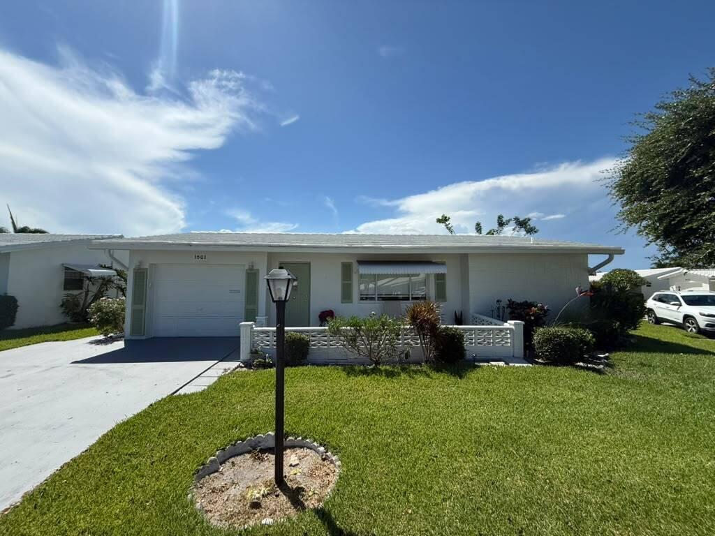 *PICTURES ARE COMING* Spacious living and effortless convenience come together in this desirable oversized Challenger model, ideally positioned on a premium corner lot with a double driveway. Enjoy year-round indoor-outdoor living from the expansive 26' x 12.5' enclosed patio addition featuring skylights and views of the private side patio shaded by a mature tree. Inside, the home offers generously sized bedrooms and renovated bathrooms, crown molding, ceiling fans, and fresh exterior paint.  Located within the vibrant 55+ community of Leisureville, residents enjoy access to three clubhouses, three pools, a private 18-hole par-3 golf course, fitness center, sauna, bocce, billiards, and a full calendar of activities.  Low HOA fees include lawn care & lawn care, exterior pressure washing, and exterior painting.