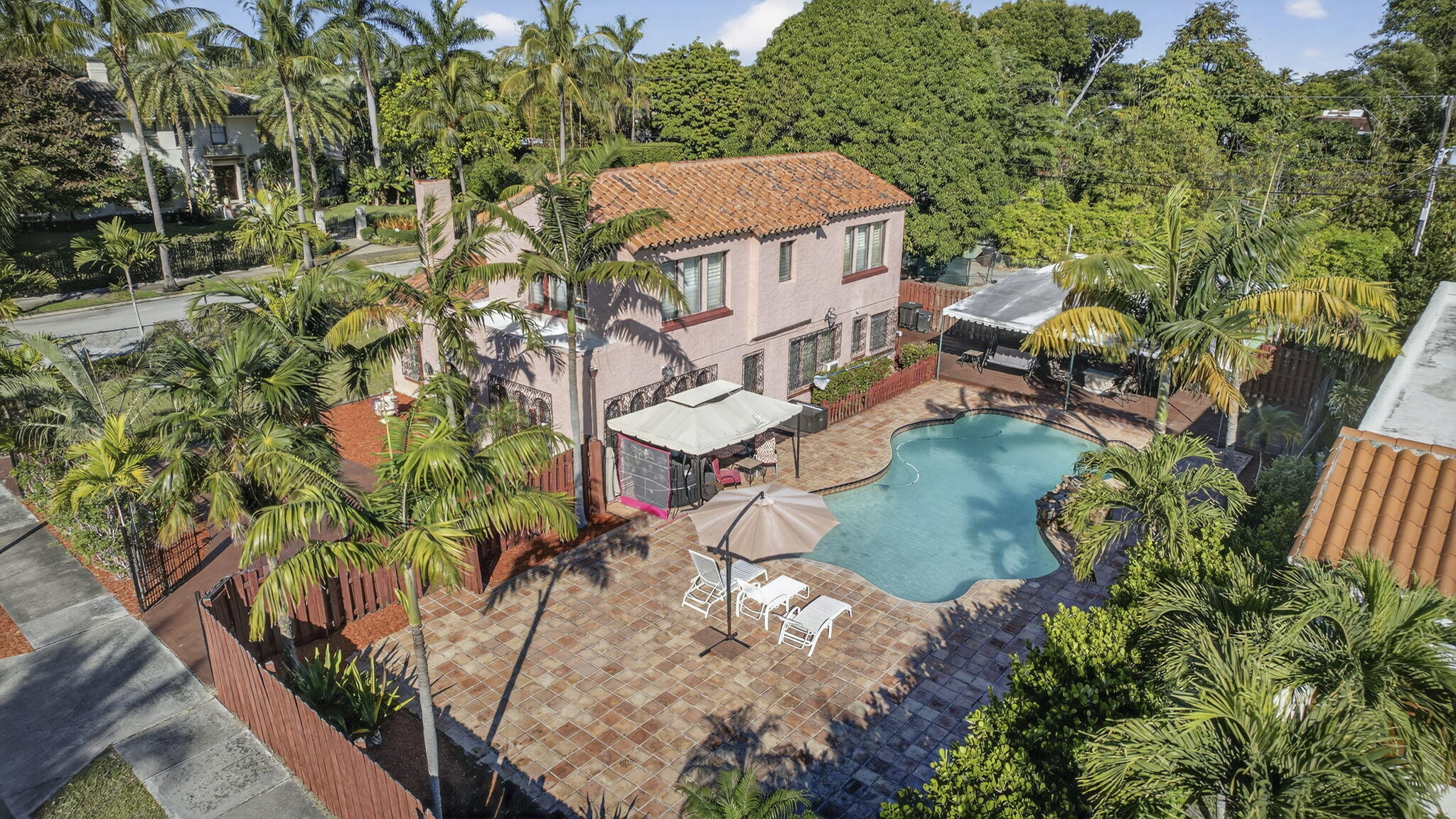 Offered for the first time in more than 40 years, this exceptional John Volk-designed residence is a rare architectural treasure in the heart of the Old Northwood Historic District, now approaching its centennial year. A true stewarded estate, the home has been thoughtfully maintained and sensitively updated to honor its original design. 
This distinguished two-story fully fenced residence offers five bedrooms and two bathrooms, with large and flexible living areas, spacious bedrooms, authentic Spanish-style flooring, and rich architectural details that reflect Volk's enduring influence on South Florida's most admired historic homes. Natural light, proportion, and craftsmanship define the interior, creating an atmosphere that is both elegant and inviting. Set on a generously sized lot, the outdoor environment features a large pool, lush landscaping, and ample space for entertaining, recreation, or quiet retreat. A detached cottage/casita with infrastructure for kitchen and bathroom already in place. This space provides exceptional flexibility for guests, extended family, or private work-from-home or office accommodations. The cottage faces one of the rare alleyways of the neighborhood, which allows for additional parking for guests to main home or cottage. 
Old Northwood is one of West Palm Beach's most coveted historic neighborhoods, established in the early 1920s just moments from the Intracoastal Waterway. Known for its mature tree-lined streets, sidewalks, and collection of architecturally significant homes -  including works by John Volk and Gustav Maass. Northwood offers a rare sense of character and community while remaining close to downtown West Palm Beach, the up-and-coming Nora district, Northwood Village, Palm Beach, and area beaches. Northwood sits at the edge of the 35.5M Currie Park redevelopment project. Set to be completed by 2027. 
This is your rare opportunity to become the next caretaker of a true architectural gem - where history, privacy, and refined living converge.