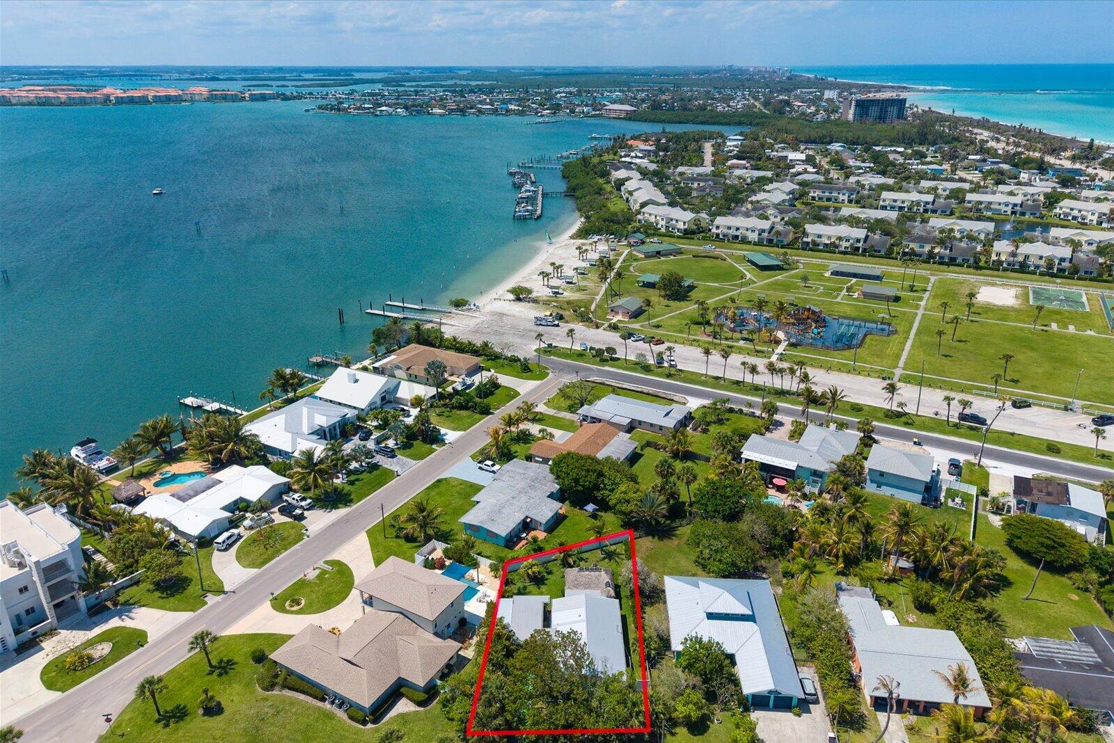 PRIVATE BEACH ACCESS just steps from your front door. This 2 Bedroom + Den beach home on South Hutchinson Island blends Old Florida charm with modern comfort & a true island lifestyle. GOLF CART & BOATER FRIENDLY, positioned between the OCEAN & INTRACOASTAL with quick access to beaches, dining, & the inlet, minutes to Jaycee Park. Set on a deep, FULLY FENCED LOT with upgraded landscaping & mature palms, offering RARE PRIVACY. From the front yard, you can HEAR THE OCEAN. Backyard features a CUSTOM TIKI HUT, fire pit, & outdoor shower. Upgrades include a 2022 METAL ROOF & IMPACT WINDOWS, Florida-style shutters, quartz countertops, renovated bathrooms, tankless water heater, enclosed garage door carport, covered storage, & a secure lock and leave with INCOME POTENTIAL. Ideal for second home, investment, or primary residence. Strong short-term and seasonal rental potential, subject to local regulations. Easy to show. Unique combination of private beach access, fenced yard, and outdoor living makes this property stand out on the island. Buyer to verify all measurements and rental restrictions. Room for pool.
