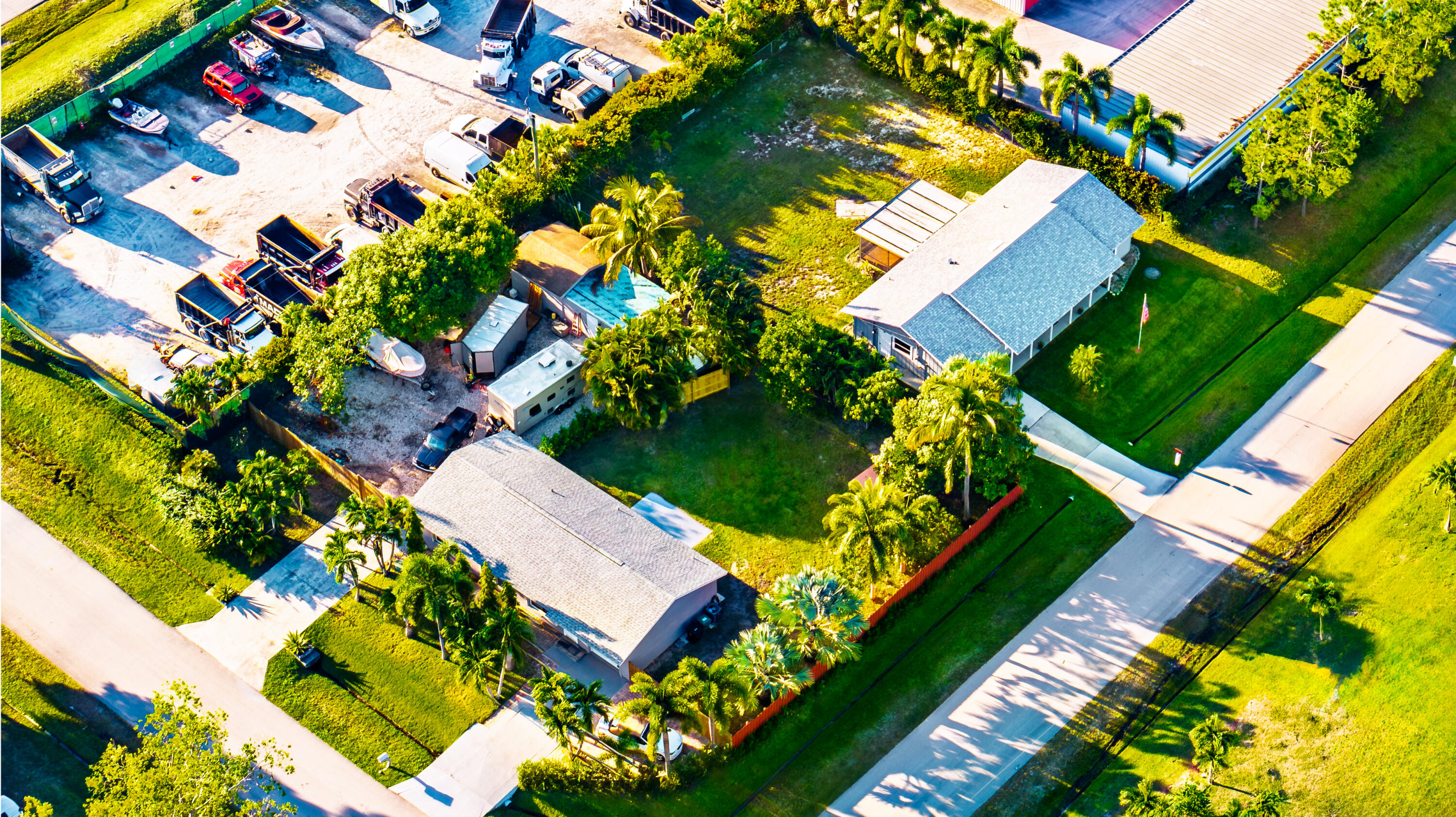 PRICE REDUCTION - SELLER MOTIVATED! BRING ALL REASONABLE OFFERS! Exceptional commercial opportunity located at 1892 SW Biltmore Street in one of the fastest-growing commercial corridors in Port St. Lucie. This rare 0.55-acre CS-zoned property offers outstanding visibility, flexible use potential, strong frontage, abundant parking, and fully fenced usable outdoor storage areas, making it ideal for contractors, investors, service-based businesses, fleet operations, or redevelopment opportunities. Positioned near both I-95 and Florida's Turnpike, this strategically located property provides easy regional access throughout the Treasure Coast, Palm Beach County, and South Florida markets. Future Land Use designation LI-CS offers long-term upside for commercial expansion, redevelopment, or light industrial-commercial applications, subject to county approvals. The property consists of two previously separate parcels that were combined, while still maintaining separate fenced operational areas, creating the potential for dual-business functionality or multiple tenant opportunities. Total building square footage is approximately 2,573 SF situated on approximately 23,750 SF (.55 acres) of land with extensive outdoor storage and parking capacity for 15+ vehicles, trailers, equipment, boats, RVs, or contractor fleets. The SW Biltmore Street building is currently leased to a Learning Center through February 2027, creating immediate income for investors. This upgraded 1,524 SF structure is situated on a 10,000 SF property and features plank tile flooring, three private office/flex rooms, two full bathrooms, updated kitchen with newer appliances, washer/dryer, garage storage, French door access to fenced outdoor areas, new roof, and central HVAC. The second structure facing Voltaire Terrace contains approximately 1,056 SF and is currently available for lease. Situated on approximately 13,750 SF of land, this renovated building includes luxury vinyl flooring, three offices/flex rooms, two full bathrooms, updated kitchen, washer/dryer, two new driveways, garage, upgraded electrical panel, new roof, central HVAC, storage shed with 220 electric, and a well that needs to be connected, along with additional fenced outdoor storage capacity. Potential uses may include contractor headquarters, landscaping companies, irrigation services, HVAC, plumbing, electrical, roofing, marine or RV storage, fleet vehicle operations, construction offices, light industrial users, distribution, training facilities, creative studios, professional offices, or investment opportunities. No HOA restrictions. Excellent opportunity for investors seeking income-producing commercial real estate, business owners requiring outdoor storage and parking, or developers looking for future upside in a rapidly expanding Port St. Lucie commercial market. Buyer to verify zoning, future land use, and all intended uses with St. Lucie County. Do not disturb occupants. Shown by appointment only.
