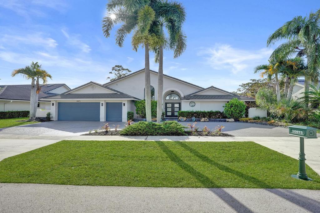 What if buying a home also meant checking into a luxury resort every single day? Experience luxury country club living in this beautifully renovated 3-bedroom, 3-bath estate home offering approximately 2,600 square feet in the prestigious Boca Woods Country Club. Perfectly positioned on a premium homesite, this exceptional residence captures breathtaking panoramic lake and golf course views stretching from the 17th tee of the newly renovated Rees Jones-designed championship golf course to the clubhouse, creating an extraordinary backdrop from nearly every room.  Completely renovated from top to bottom, this move-in-ready home showcases soaring vaulted ceilings, polished porcelain tile throughout, upgraded interior doors, abundant natural light, and a thoughtfully designed open-concept floor plan that seamlessly blends elegance with everyday comfort. Walls of sliding glass doors create effortless indoor-outdoor living, opening to an expansive covered patio with soaring ceilings, a private pool, outdoor shower, and spectacular views of the fairways and sparkling lakes, creating the perfect setting for entertaining or simply enjoying South Florida's year-round outdoor lifestyle.  The designer kitchen has been beautifully reimagined with quartz countertops, a dramatic waterfall island, glass tile backsplash, stainless steel appliances, custom cabinetry, and abundant storage, making it both functional and sophisticated. The renovated laundry room continues the same high-end finishes with matching cabinetry, countertops, and backsplash for a cohesive designer look throughout the home.  The luxurious primary suite serves as a private retreat, offering two custom walk-in closets, a linen closet, and a spa-inspired bathroom featuring dual vanities, a Jacuzzi soaking tub, oversized walk-in shower, a Toto electric toilet, and elegant finishes. The spacious guest suite includes its own en-suite bath and walk-in closet, while the third full bathroom is beautifully appointed with a skylight and oversized glass-enclosed shower. Every closet throughout the home has been customized with built-in organization systems.  Additional upgrades include a 2020 roof, two 2019 air conditioning systems, a 2025 water heater, Nest smart thermostats, Ring doorbell, an FPL electric vehicle charger, and a spacious circular driveway. The original two-car garage was professionally reconfigured to create an oversized laundry room and a third full bathroom, significantly enhancing the home's functionality and living space. As a result, the garage comfortably accommodates one vehicle and the included golf cart, while the expansive circular driveway provides ample additional parking. Furniture is negotiable.  Located within the exclusive gated community of Boca Woods Country Club, residents enjoy an exceptional private club lifestyle featuring two championship 18-hole golf courses totaling 36 holes of golf. The multimillion-dollar club transformation also includes a beautifully renovated clubhouse with exceptional dining, elegant social spaces, an active year-round calendar of events, Har-Tru tennis courts, pickleball courts, a state-of-the-art fitness center, spa services, card rooms, and a welcoming, vibrant membership. With approximately 640 homes, Boca Woods offers an intimate country club atmosphere where luxury living, championship golf, resort-style amenities, and an active social lifestyle come together in one of Boca Raton's most desirable private communities.  Mandatory membership includes a one-time $150,000 initiation fee. This is a rare opportunity to own a fully renovated home with spectacular lake and golf course views while enjoying one of South Florida's premier private country club lifestyles.