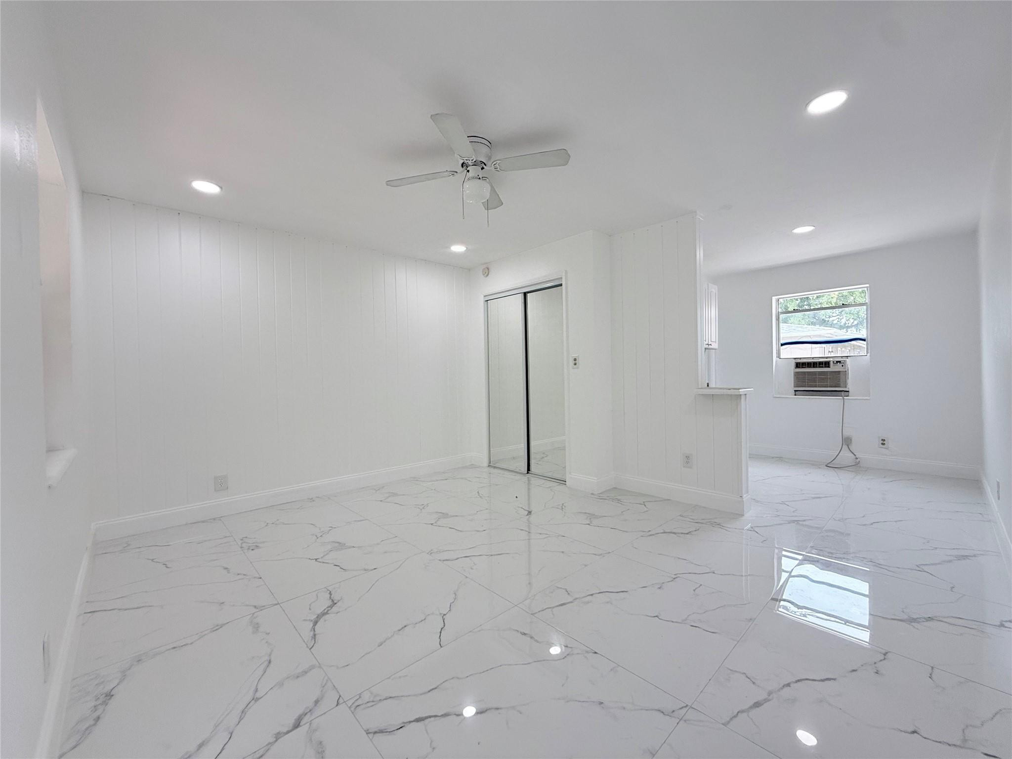 Newly Renovated Studio Apartment in the Heart of Hollywood, FL! This sleek and modern studio apartment offers the perfect blend of comfort and convenience. Featuring stunning porcelain marble-look tile floors throughout, the space is bright, airy, and move-in ready. The open-concept layout includes a compact kitchen with granite countertops and white cabinetry, perfect for easy meal prep. Enjoy a stylish bathroom complete with a walk-in shower, modern fixtures, and matching marble-style tile. Additional highlights include a wall-mounted A/C unit, ceiling fan, recessed lighting, and plenty of natural light through updated windows. Located in a quiet residential area, this studio is just minutes from downtown Hollywood, beaches, and major highways.