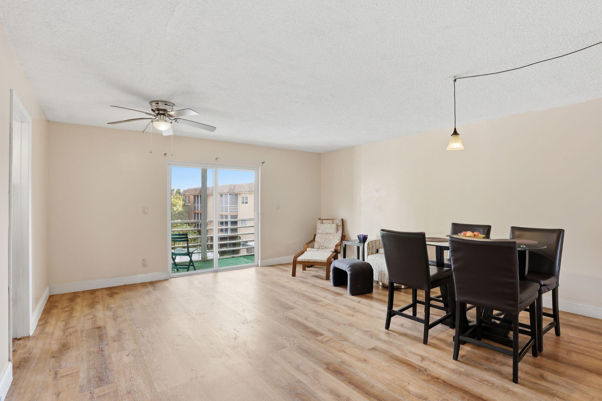 Welcome to this well-maintained 2-bedroom, 1-bathroom third-floor condo with a pleasant pool view. The unit features impact windows throughout and vinyl plank flooring in the living, dining, and bedroom areas. The kitchen offers granite countertops (2013) and a white refrigerator replaced in 2016-2017. Additional updates include AC replaced in 2020-2021, water heater (2015), new baseboards, and recently replaced ceiling sheetrock. The primary bedroom includes blackout shades, new shelving, closet doors, and a dark wood ceiling fan. Community laundry is conveniently located on the same floor with an additional facility on the second floor. The unit was previously under contract but financing fell through due to buyer's loss of employment.
