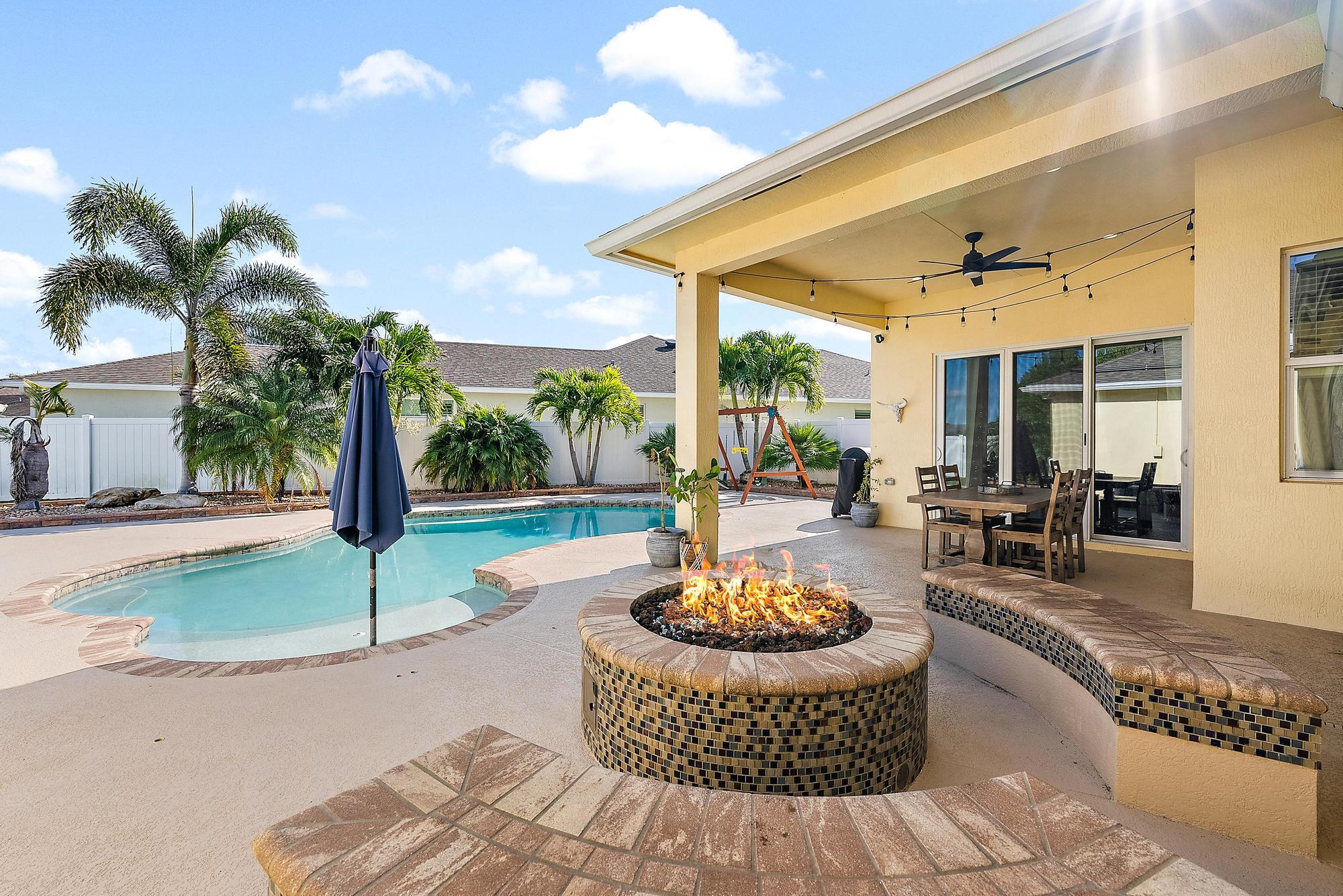 Leased until May 31, 2026. This 3-bedroom home, with flexible den or fourth bedroom, along with 2 full bathrooms comes complete with a plethora of upgrades: Solar powered saltwater pool with water fountains, a sun shelf, and solar heated. Newly installed turf for a maintenance-free lawn and perfect for pets. A covered patio with a custom-built gas fire pit and stone seating. This expansive backyard has space for a potential summer kitchen, cabana bathroom, or tiki bar complete with a gas hookup. Features include complete impact windows,  luxury vinyl plank (LVP) flooring with 5'' baseboards, Stainless appliances, with gas cooktop, wall ovens, alkaline water filtration system, and LG Thinq front-loading washer and dryer with utility sink. The primary suite offers a cozy nook perfect for an office, nursery, or reading area. The ensuite features dual sinks, his-and-hers walk-in closets with organizers, and a large tiled walk-in shower. The three car garage features a built out attic for ample storage and an additional 3 feet added to driveway pavers on each side for larger vehicles, trucks and toys. This home and community has precedence with Primrose private school that is a short walk or golf cart ride around the corner. 
Located just a short walk to Tradition Square, you'll enjoy a vibrant lifestyle with excellent dining, shopping, and recreation options. With easy access to I-95 and the Cleveland Clinic, this home offers unmatched convenience. The HOA fee at Bedford Park includes community pool, landscaping, pest control, lawn maintenance, cable, high-speed internet. Tradition's cheerful Town Center reimagines small town living with fresh, modern amenities and experiences without sacrificing nostalgic charm and close-knit community - where residents can start a new life chapter filled with opportunities to learn, grow, and create new memories. This area creates a natural community hub for residents to meet and socialize, where events like a weekly farmers market invite one and all to gather. An adjacent amphitheater brings an entertainment venue to Tradition for year-round community enjoyment of performances such as concerts, theater, dance, comedy, and more.