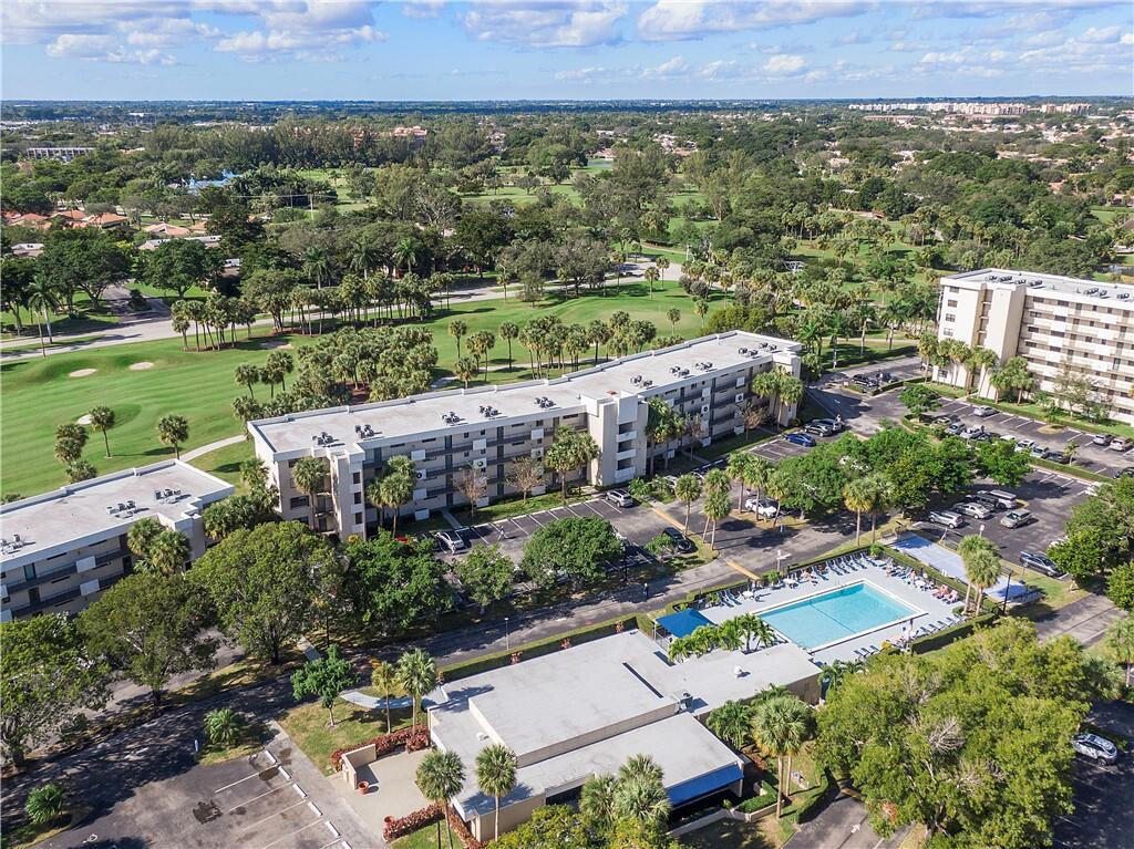 Imagine waking up to breathtaking golf course views from your private screened balcony, the perfect place to enjoy morning coffee or unwind after a long day. This beautifully updated home features a remodeled kitchen with granite countertops, stylish backsplash, and convenient peninsula for effortless meal prep, along with tile flooring throughout for a clean modern feel. The spacious layout includes a versatile Murphy bed in the living area, custom closet built-ins for exceptional storage, and the convenience of a full-size washer and dryer right in the unit. Both bathrooms have been tastefully updated, while major improvements including a new A/C, hot water heater, and updated electric panel provide peace of mind. Enjoy resort-style living at The Palms.