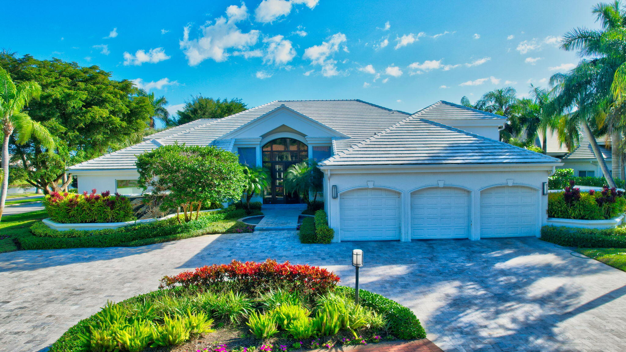 Beautifully renovated 4 bedroom + office home on an OVERSIZED LOT (0.43 acre) with magnificent lake & golf course views in St. Andrews Country Club! The exterior has a Travertine circular driveway and all doors are impact glass. The interior is light and bright, with an open floor plan and floor-to-ceiling windows. Renovated kitchen features high gloss cabinets and double refrigerator. The master suite has 2 walk-in closets and a renovated bathroom with double shower heads and 2 water closets. All guest bedrooms are ensuite, and all bathrooms are renovated. Outside is a very spacious patio area with Travertine marble pavers, 42 ft. lap pool with spa, and private lake and golf course views.