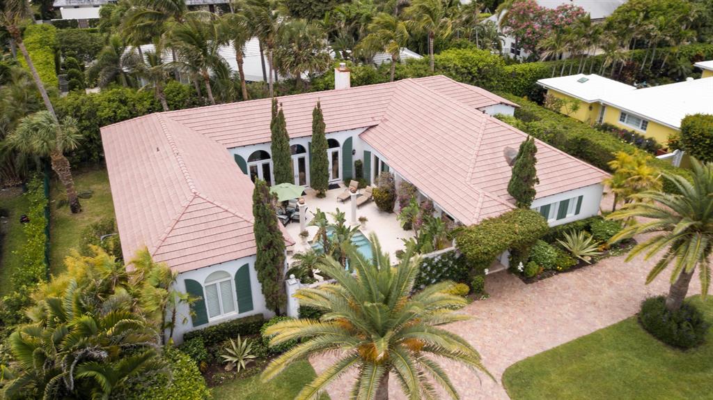 This unique Palm Beach Courtyard home sits on a quiet residential island enclave on the desirable Palm Beach's Southend and boasts 3,146 square feet of interior living space with 3 bedrooms, 3 full baths, 2 car garage and old brick circular drive. Designed by Ballinger Award winning architect, Raphael Saladrigas, the interior features an expansive great room with lofty tray ceilings, beautiful marble floors with Verde S. Denis marble accents in the foyer and fireplace surround. The mantel piece is from the late 1800's. The master en-suite has double walk-in closets and marble appointed bathroom with double sinks. Both the master en-suite and the great room, open to the private courtyard, a tranquil outdoor living area featuring a fountain, heated saltwater pool and a relaxing tropical setting.
This property is ideally located within walking distance to Phipps Ocean Park Beach and Raymond Floyd Golf Course.