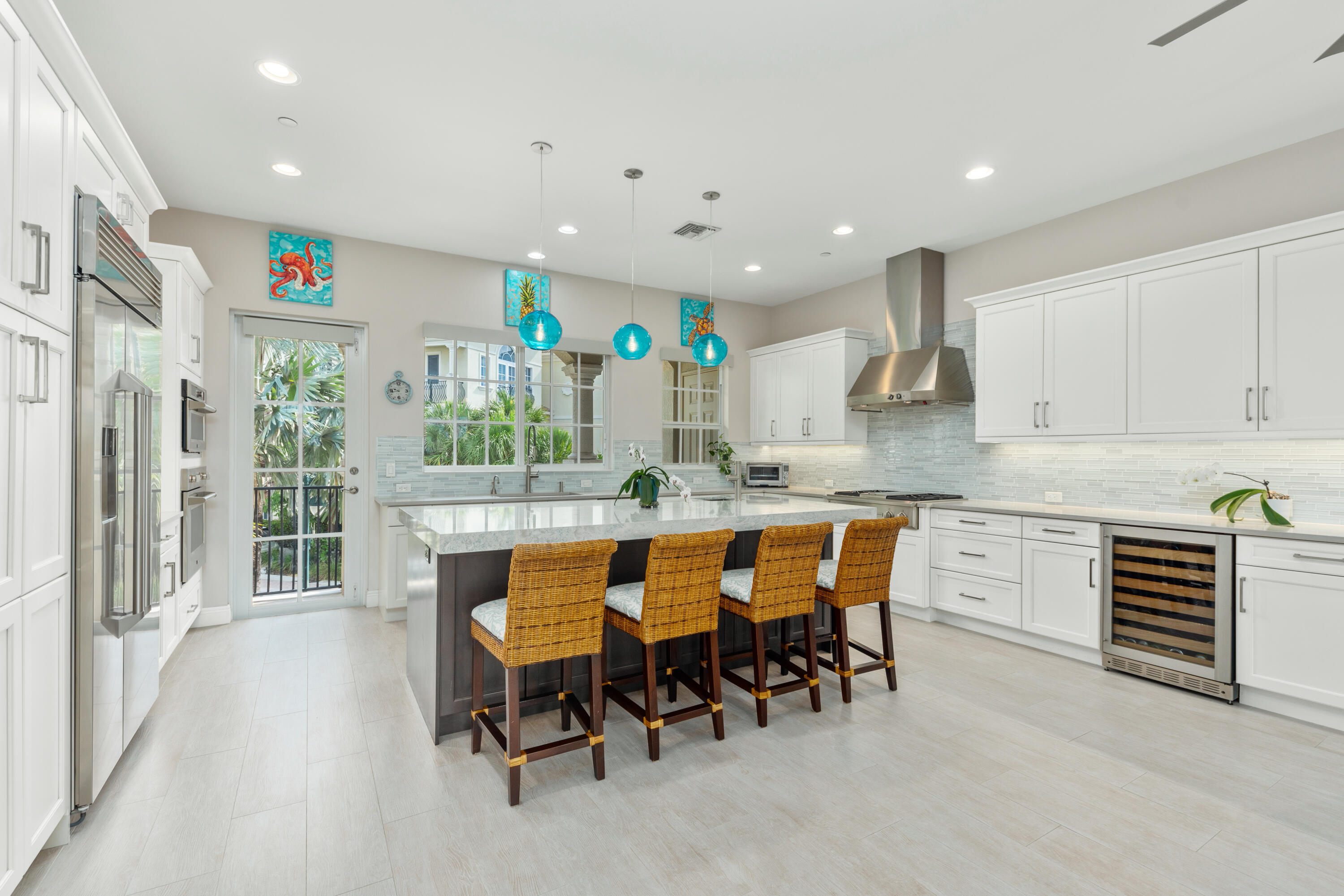 Tucked away in an intimate gated community just one block from Jupiter Beach, this beautifully designed corner townhome offers peaceful preserve views and exceptional privacy. With approximately 3,440 square feet under air and 4,400 total square feet, the residence features 3 bedrooms, a private office, 4 full bathrooms, and a spacious open floor plan designed for both everyday living and entertaining. Soaring ceilings and expansive impact glass windows fill the home with natural light, while the gourmet kitchen features Monogram appliances, including a gas cooktop, custom cabinetry, quartz countertops, and an oversized center island that serves as the heart of the home. SEE MORE REMARKS...  Additional highlights include a private elevator servicing every floor, oversized porcelain tile flooring, custom closet systems, electric blinds, and multiple outdoor living spaces. Three balconies and a private patio provide plenty of room to relax, entertain, and enjoy the tranquil preserve views. Built with solid concrete block construction, the townhome is part of an intimate community of only 20 residences with a private pool and gated entry. Located just one block from Jupiter Beach and moments from the Jupiter Riverwalk, residents enjoy easy access to Harbourside, waterfront dining, shopping, the Jupiter Inlet, and the iconic Jupiter Lighthouse. Whether you're spending the day at the beach, boating, paddleboarding, snorkeling, fishing, or simply enjoying the many restaurants and shops nearby, this home offers an exceptional opportunity to experience the best of Jupiter's coastal lifestyle.