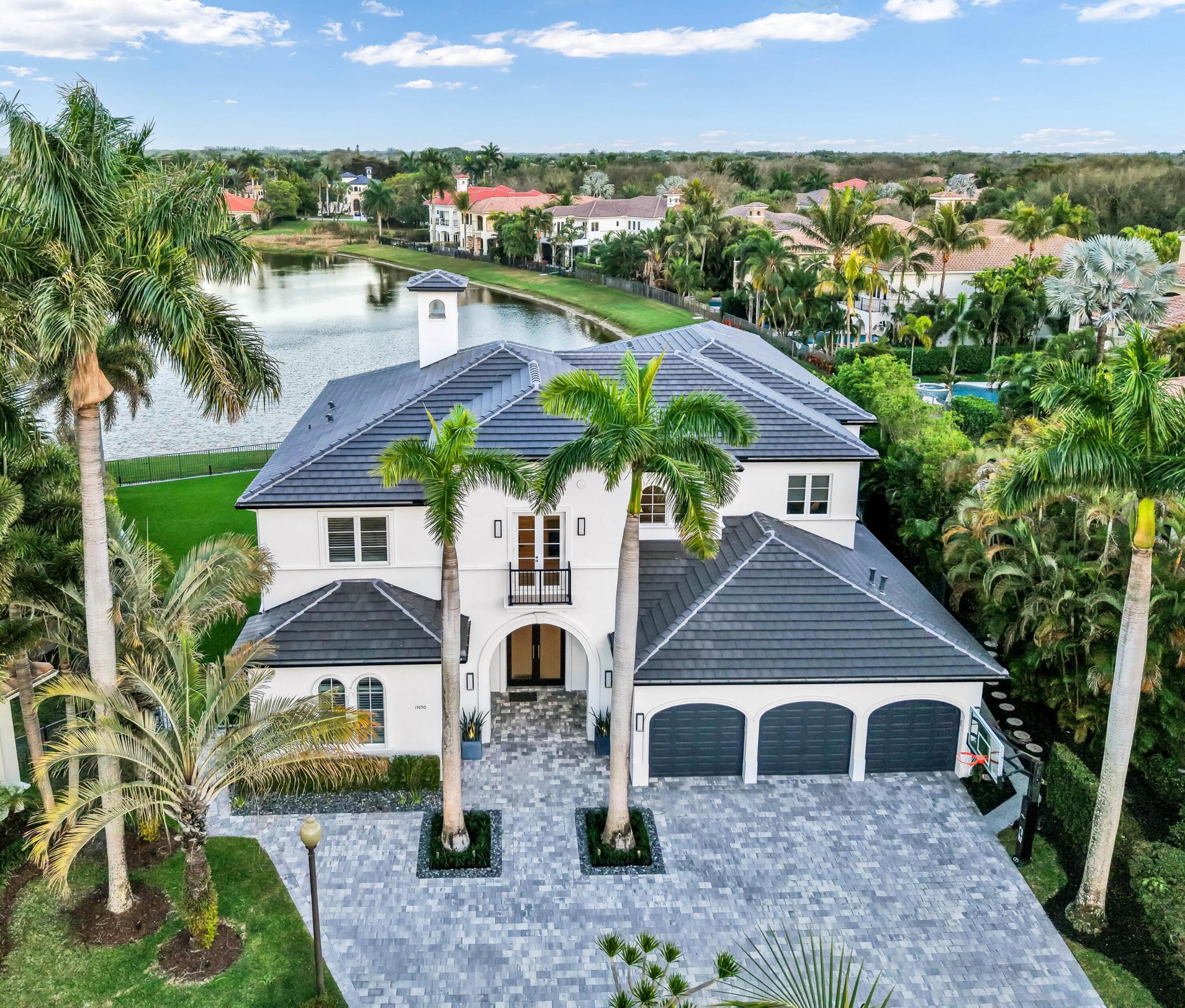 One of the finest turnkey lakefront opportunities ever offered in Boca Raton. This 5 bedroom estate plus office, loft, and expansive club room also features a spacious 3 car garage and is situated on a premier point cul de sac lot with expansive lake views. Spanning nearly 7,000 square feet under air on over a third of an acre.
Completely renovated in recent years, the home features a 2024 roof, all new bathrooms, full impact windows and doors, a whole house generator, a water leak detection system, an elevator and designer upgrades throughout. The interior showcases tray ceilings, custom built closets in every room, central vacuum, surround sound throughout, a gas fireplace, and a stunning glass banister staircase. 

The new kitchen is a true showpiece, outfitted with Wolf appliances, Sub Zero refrigerator, waterfall quartz countertops, wine refrigerator, Lambo wine cooler, and a double walk-in pantry for exceptional storage.
The first floor offers a spacious club room and an Ensuite, ideal for guests or additional living space.
The primary suite upstairs serves as a true retreat, featuring two oversized walk-in closets, a bonus space perfect for a home gym or office, and a large private balcony overlooking the backyard and lake. The spa inspired primary bath includes dual sinks, floating vanities, a separate soaking tub, and a glass enclosed shower.
Step outside to experience the ultimate Florida lifestyle. The backyard and saltwater heated pool were completely remodeled in 2022 and are complemented by a new covered summer kitchen, extended lanai for additional entertaining space, and expansive turfed play areas on both sides of the property. Whether hosting large gatherings or enjoying peaceful sunsets, this outdoor space is truly exceptional.
Located within The Oaks, residents enjoy a world class lifestyle featuring a 25,000 square foot clubhouse, resort style pool, state of the art fitness center, and a wide variety of instructor led classes including HIIT, Pilates, yoga, water aerobics, Zumba, and more. The award winning tennis complex offers over 10 courts, along with basketball and pickleball courts. The on-site spa provides both facial and body treatments, and residents can enjoy the community's café and restaurant all without the high costs of a traditional country club.