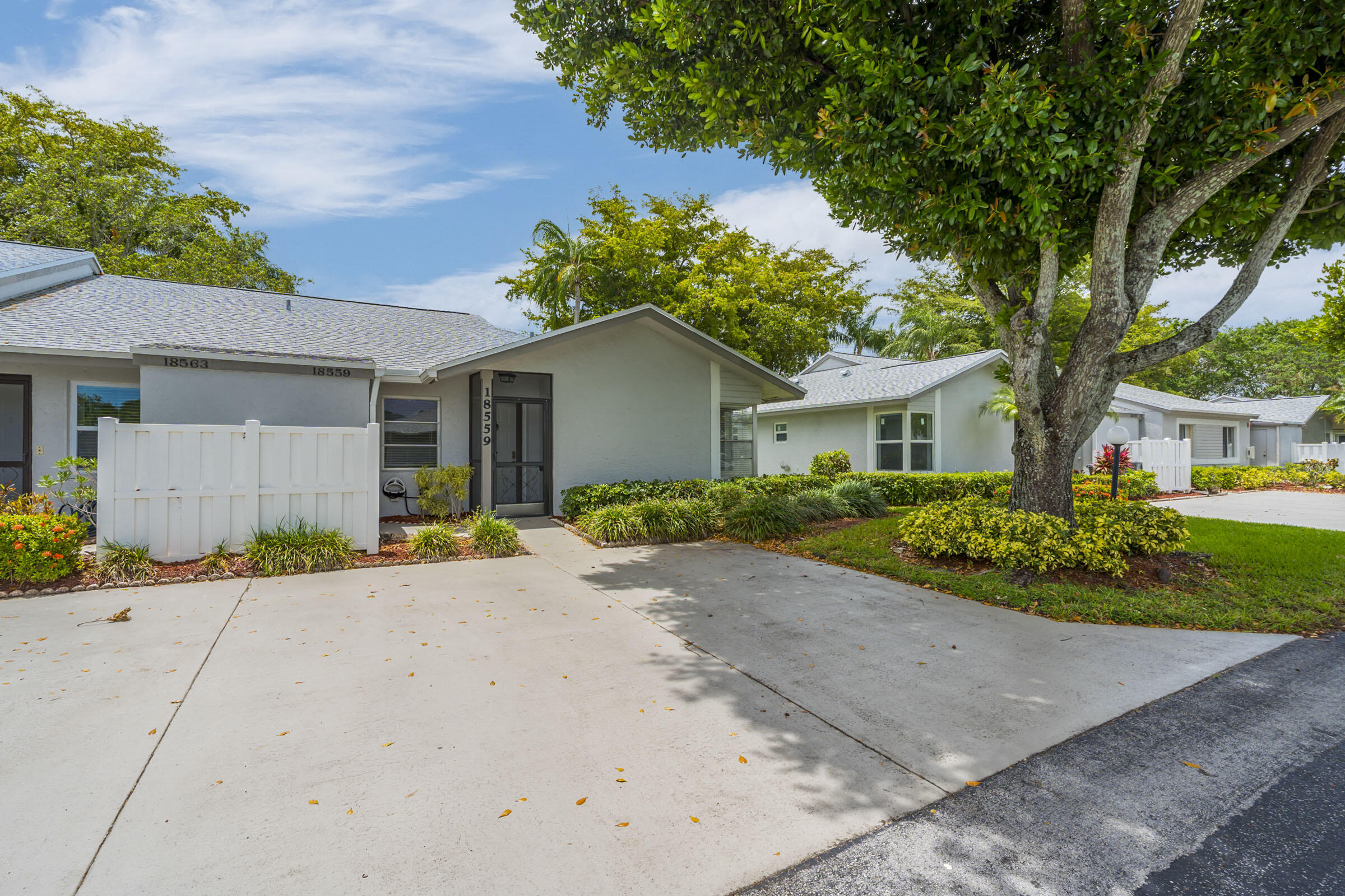 Welcome to Whisper Walk, a desirable 55+ gated community in Boca Raton. This RARE CORNER UNIT is filled with natural light, featuring extra windows and vaulted ceilings. This 2BR/2BA home offers an open layout with an updated kitchen, appliances, and bathrooms. Ceramic tile and laminate flooring throughout, along with a spacious primary suite, walk-in closets, and in-unit laundry. Enjoy relaxing in the private screened-in patio. HOA includes cable, internet, water, roof maintenance, insurance, and full amenities—clubhouse, pool, fitness center, tennis, spa, and more—providing easy, low-maintenance living. Conveniently located near shopping, dining, and major roadways. Move-in ready and a must-see!