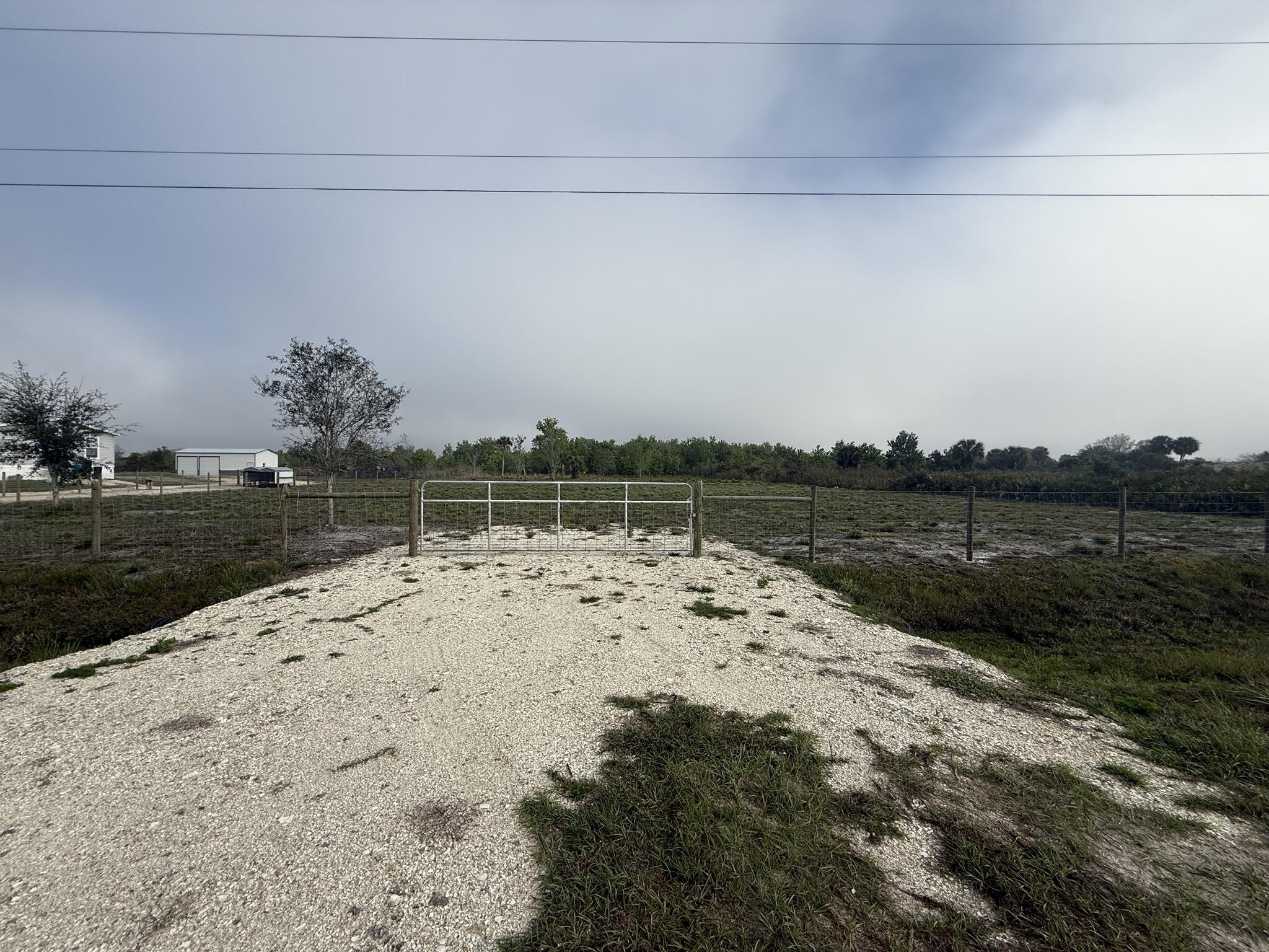 Rare opportunity in Okeechobee! Two adjoining parcels being sold together as one expansive 2.5-acre homesite. Conveniently located just off Peavine Trail, a main paved road, this property offers easy access while maintaining a peaceful, rural setting. Approximately 1.50 acres have already been cleared, saving you time and money. Property features an installed culvert and fenced frontage for added convenience and access. Electricity is available at the street, making it easier to plan your future build or investment. Plenty of room for your custom home, workshop, or recreational use. Don't miss this versatile land opportunity in a growing area!