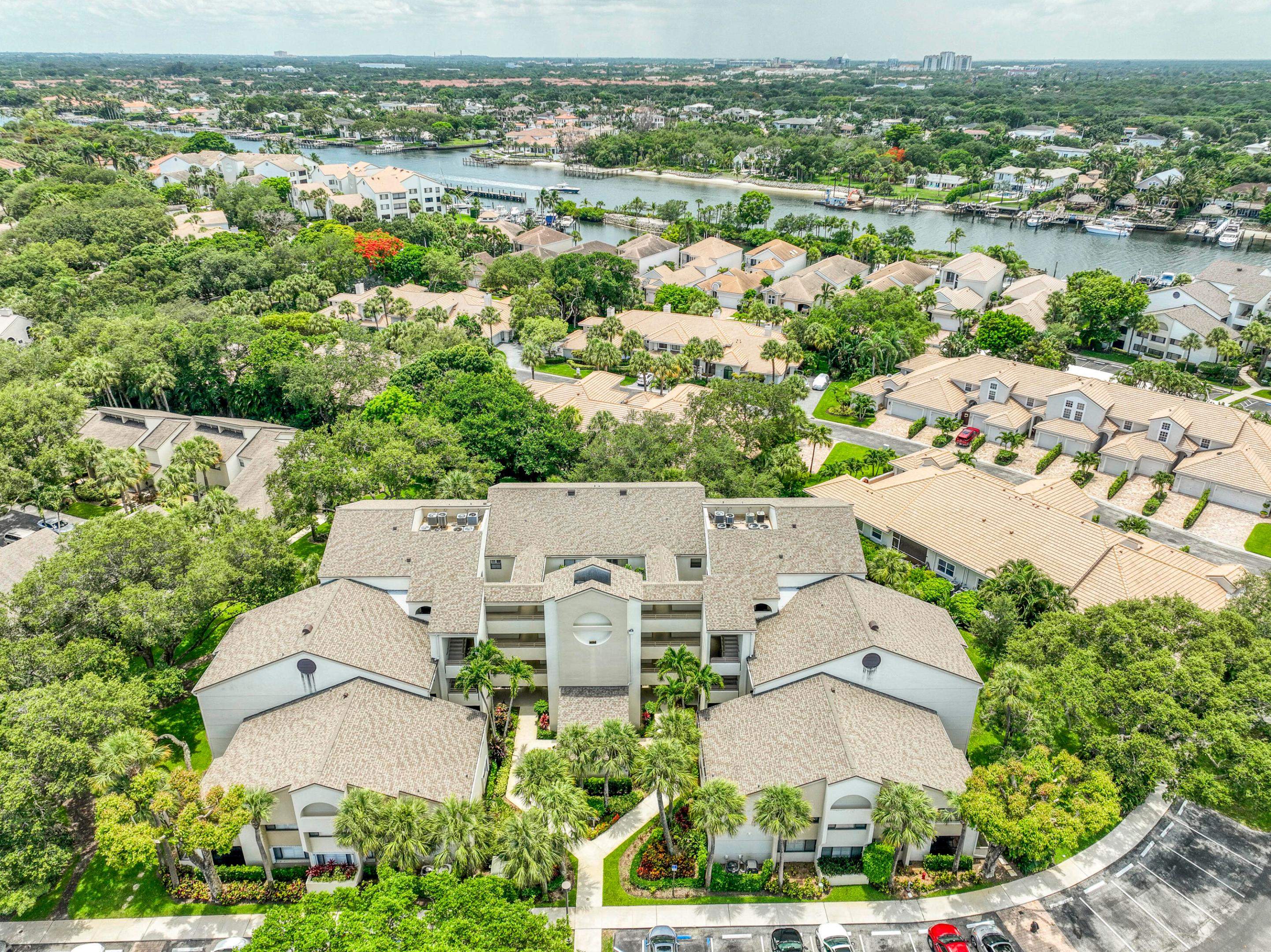 Renovated contemporary-style 2BR/2BA condo in Juno Beach's gated waterfront community, Oak Harbour. Enjoy an open floor plan with kitchen bar-top seating, a separate dry bar for entertaining, and a private primary suite. The enclosed patio adds additional living space or can be opened up for a breezy outdoor setting - surrounded by lush greenery and mature oak trees for both privacy and a peaceful view. Oak Harbour offers 24/7 manned security and resort-style amenities, including a marina with available boat slips, two pools, tennis courts, and a clubhouse. Ideally located just minutes from Jupiter's pristine beaches, top-rated dining, shopping, and major roadways. Whether you're seeking a full-time residence or a luxury seasonal retreat, this move-in ready home offers the best of  Jupiter's coastal lifestyle.
