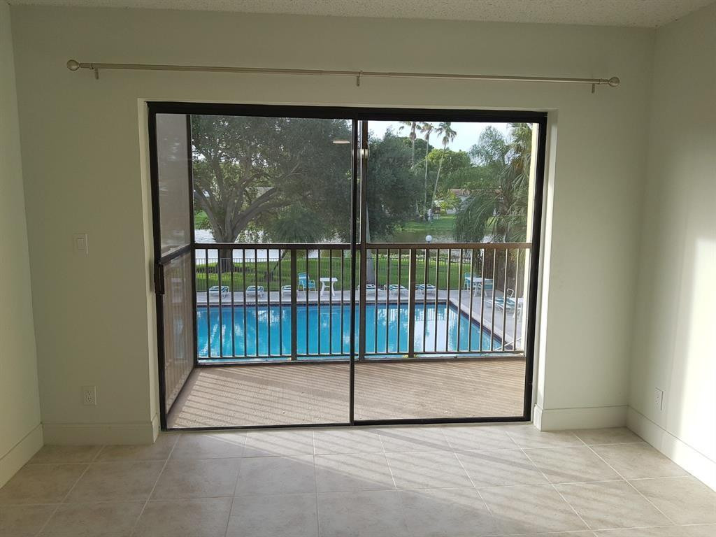 Beautiful views of the lake, pool, and green. Beautiful updated kitchen and new stainless steel appliances. Ceramic tile throughout, one of the few units with a screened-in balcony overlooking the lake and pool. Mint condition. Brand new washer and dryer. A/C and water heater 3 years old. Excellent school district. Centrally located. Freshly painted. All neutral colors. Welcome investors! Can be rented right away. THE BEST VIEW IN THE BUILDING!  Easy to show. Just text LA date and time then supra
