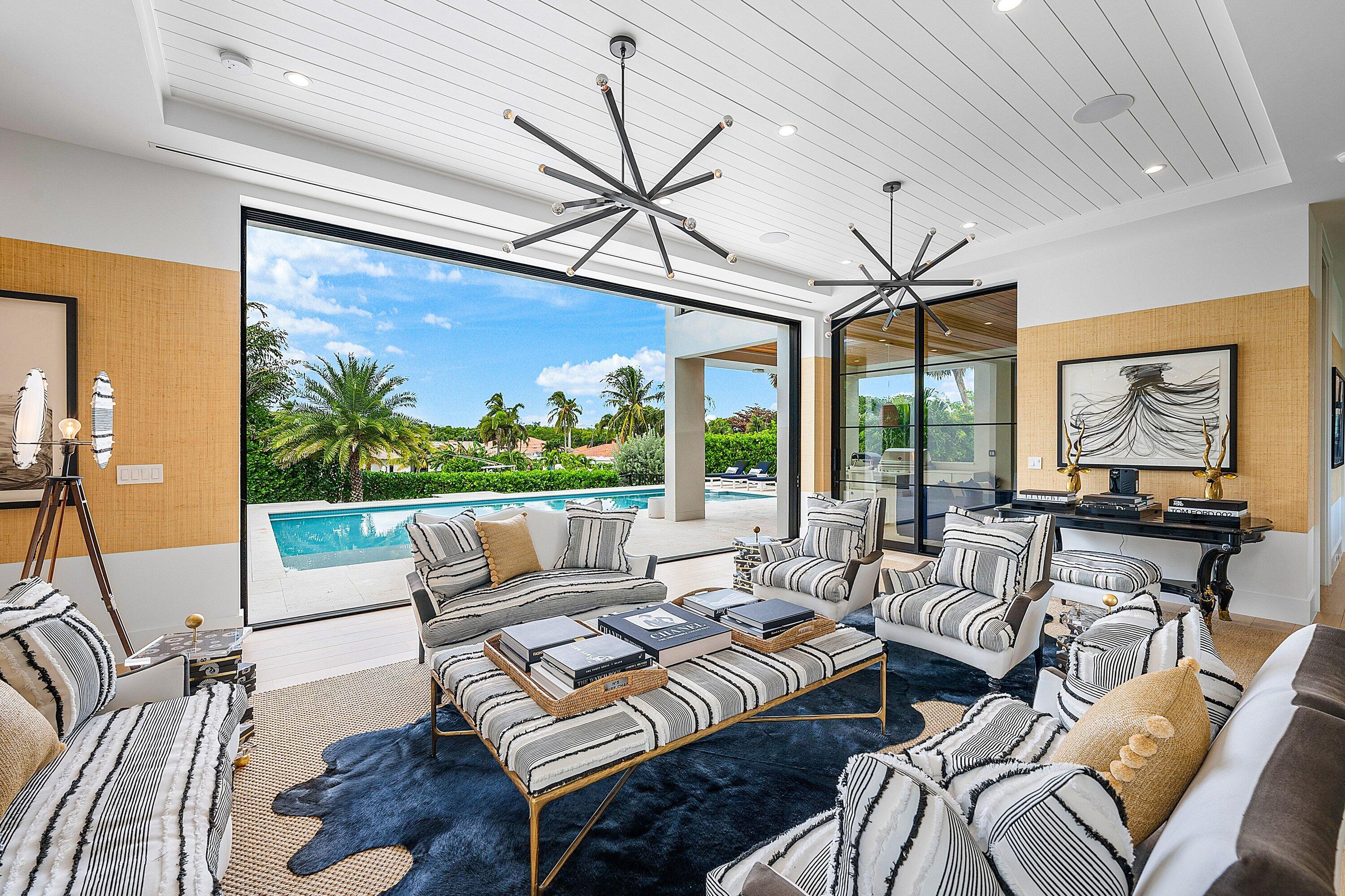 Welcome to 10 Harbour Drive S in Ocean Ridge, Florida — an exclusive coastal enclave where quiet sophistication meets the very best of South Florida living. Completed in 2022, this remarkable home reflects impeccable taste and thoughtful design at every turn, blending contemporary architecture with warm, timeless elegance.

Ideally positioned just moments from the beach and the conveniences of Palm Beach County, the residence offers 4,424 square feet of air-conditioned living space and 5,825 total square feet designed for refined living and effortless entertaining. Upon entry, an expansive great room unfolds with floor-to-ceiling glass and fully retractable sliders, creating a seamless connection to the outdoor living spaces. Marble and wood flooring flow throughout, reinforcing home's clean lines, curated materials, and elevated modern aesthetic. A formal dining room sits just off the main living area, providing an elegant setting for gatherings and celebrations. The bespoke kitchen is a true centerpieceequipped with top-tier appliances, custom cabinetry, quartz countertops, and a spacious pantry designed for both beauty and function. Whether you're cooking casually or hosting guests, this kitchen with top shelf appliances custom cabinets and quartz counters delivers the perfect blend of performance and luxury. The primary suite, located on the main floor, offers a serene private retreat with luxurious finishes and a spa-inspired atmosphere. Upstairs, three additional bedrooms and two beautifully appointed baths provide comfort and privacy for family and guests. With a total of four bedrooms, three full baths, and two half baths, and 3 car garage the home is designed to accommodate both relaxation and entertainment with ease. Outside, the true essence of Florida living comes to life. A large salt water pool, spa and summer kitchen overlook lush tropical landscaping and tranquil water views that stretch toward the Intracoastal. The seamless indoor-outdoor flow makes this home ideal for sunny afternoons, quiet evenings, or unforgettable gatherings with friends and family.