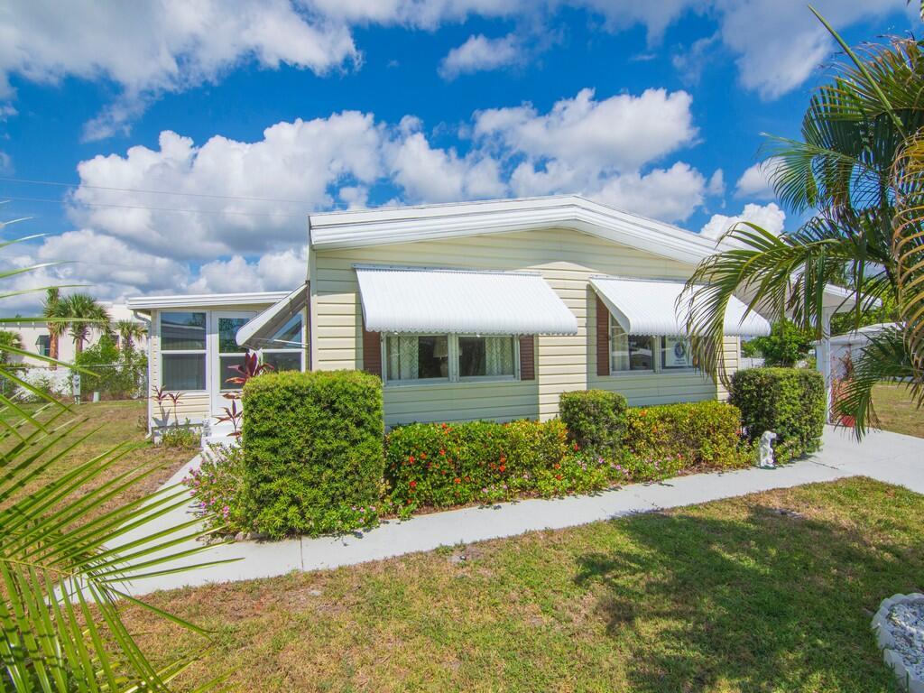 BRAND NEW AC, new dishwasher and new washer.  Comes with a separate golf cart entrance. Large Florida room with its own AC system. Incredible value for this remodeled home.  Lot rent is $805 per month and includes the amenities of the clubhouse, trash removal, recycling and basic cable package.  Schedule your tour today and start enjoying the Florida lifestyle.