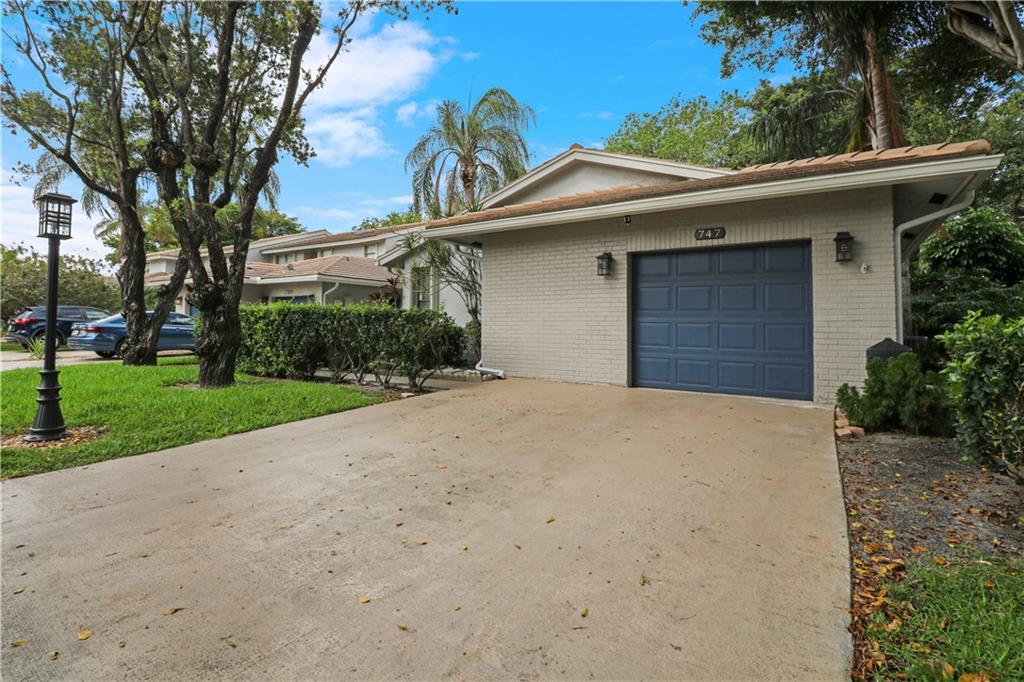 Beautifully remodeled 2 bedroom/2 bathroom villa with 1 car garage and serene lake views located in the non-mandatory Deer Creek Golf Community. New kitchen with shiplap ceiling, new stainless appliances and guartz counters tops.  Two new bathrooms with walk-in showers.  Wonderful split floor plan with foyer entry and new ceramic tile throughout. Additionally, there is an enclosed sunroom under air. New Electrical panel upgrade with direct plug in for home generator. Pool, golf course and club house only steps away. Just a 4 mile drive to award winning Deerfield Beach.