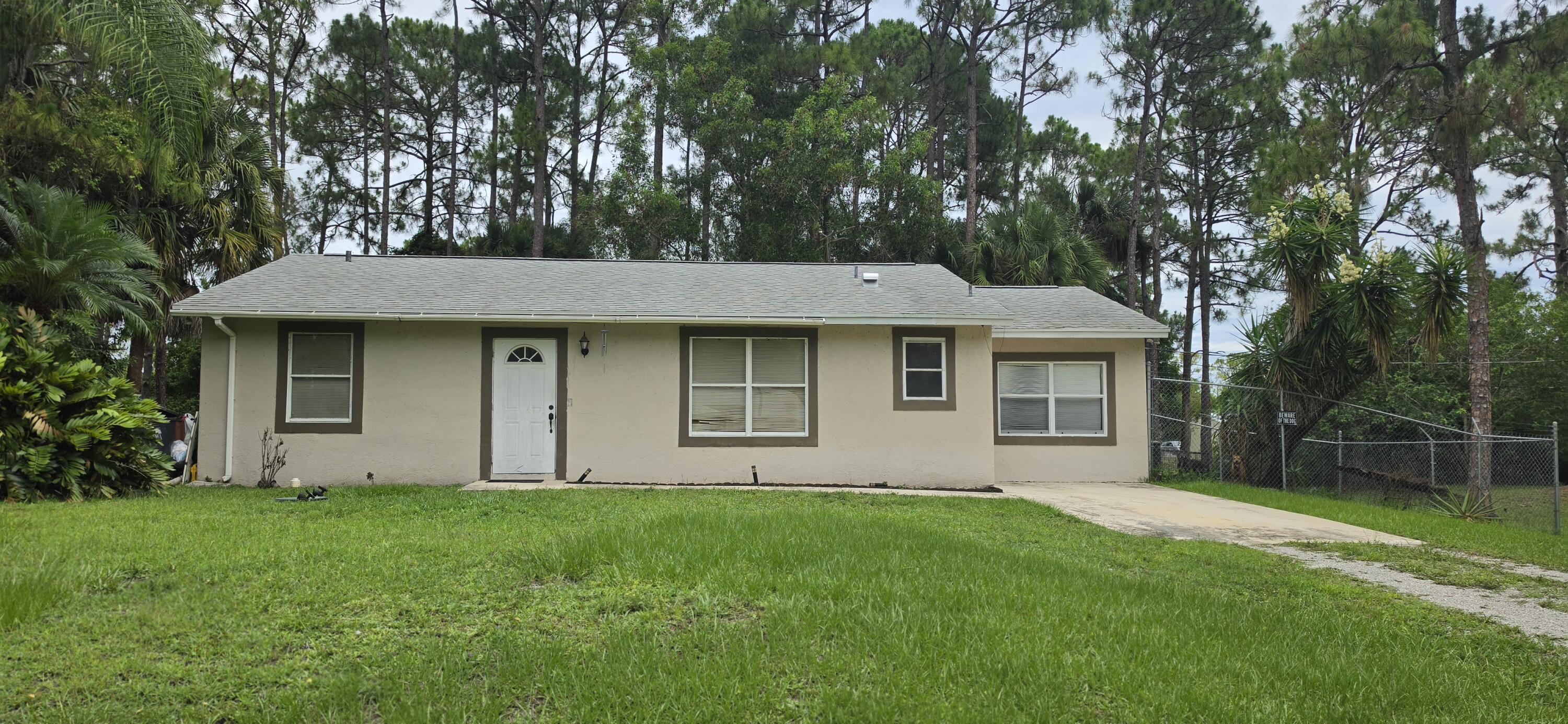 Opportunity knocks. This house can be revamped to be that charming little starter home that it once was. Mostly cosmetic repairs needed but the house has good bones and just needs a little TLC. 4 bedrooms and 2 baths. Roof is 2023, paver patio and fire pit area 2022, water heater 2026. The kitchen features updated cabinetry, stainless appliances, granite counters and overhead lighting. Baths have updated cabinetry and granite counters. 2024 water system professionaly maintained. Mature trees including a honey mango and beautiful Flame tree. Close to schools, restaurants and local shopping.