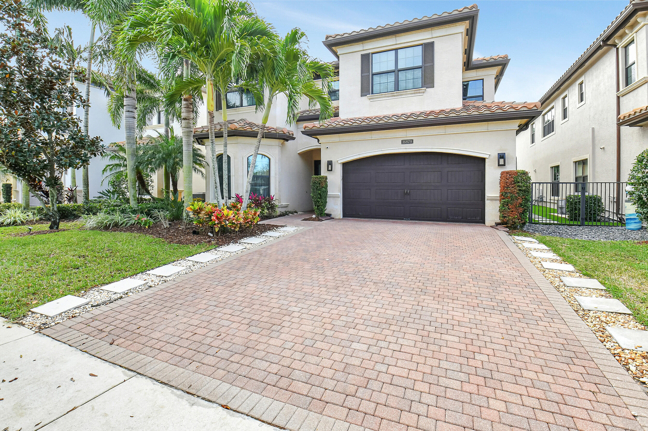 Experience luxury living at its finest in Delray Beach's highly sought after Bridges community. This newer Manchester model offers 5 spacious bedrooms, 5 bathrooms, and a large loft, with over 4,000 square feet of beautifully designed living space and 5,069 total square feet, providing exceptional comfort for families of any size. Step inside to a meticulously upgraded interior showcasing designer finishes, custom built ins, a stunning fireplace, and wood and tile flooring throughout. The open concept layout flows effortlessly from the elegant  dining area to the inviting living space and into the gourmet kitchen, complete with gas cooking, top of the line appliances, and abundant storage. The current owner spared no expense. Enhancements include motorized outdoor screens, a heated pool and spa, full house generator, impact windows and doors, and two new A/C systems, ensuring comfort, convenience, and peace of mind year round. Residents of The Bridges enjoy an unmatched lifestyle with resort style amenities: a grand clubhouse, state of the art fitness center, tennis and pickleball courts, basketball courts, playground, restaurant, and a spectacular community pool. The location is ideal close to A rated schools, premier shopping, dining, entertainment, and the beach making every day feel like a vacation. This is a rare opportunity to own a truly exceptional home in one of Delray Beach's most prestigious neighborhoods. Schedule your showing and make your dream of luxury Florida living a reality.