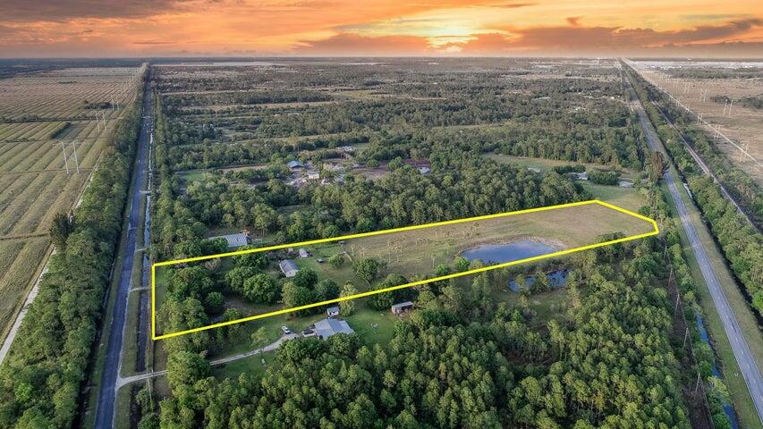 9.05 ACRE property with 4bed/2Bath ranch! Property has access to both GLADES & CARLTON RD - Zoned AG-5 - TOP, TOP, TOP LOCATION with new developments, Tradition, schools, shopping, and just minutes to I95!! ***Zoning allows another residential home on the property!!! Existing home is a 4/2 ranch style home, high and dry (3ft above road), with a pond/lake! 7 acres are cleared! - Great potential and investment! Perfect property for horses, nursery or a tree farm! The property is securely fenced with 6' posts every 10'feet.