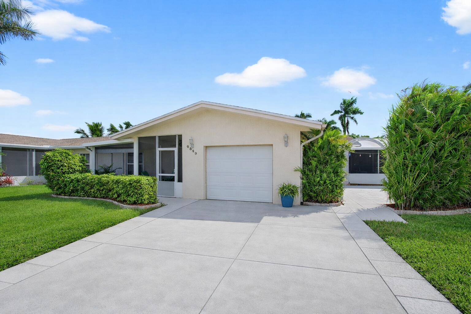 Welcome home to this move-in-ready corner-lot villa, ideally located on one of the best blocks in the highly desirable Delray Villas 55+ community in Delray Beach. - With one of the lowest HOA fees in Delray Beach, this bright & inviting home offers brand-new stainless steel kitchen appliances, hurricane impact windows, sliding doors, & garage door for added safety and peace of mind, plus a new energy-efficient A/C & water heater (2025).  - Enjoy the oversized yet cozy screened & covered front porch, naturally lit open living & dining areas, & an open kitchen with abundant counter space, spacious cabinetry, & convenient roll-out drawers.  -  Additional upgrades include updated lighting in the baths, living & dining rooms, built-in family room cabinetry, modern interior doors, custom closet shelving, plantation & cafe shutters, & custom up/down shades.  - Relax on the upgraded screened and covered rear patio with vaulted ceiling or entertain on the spacious paved patio area complete with a BBQ nook and privacy hedge. Super clean, bright, and comfortable - come see it and make it your own!  - Delray Villas - Plat 4/5 is a non-gated 55 plus community situated between Lake Ida Road and Via Delray, off of El Claire Ranch Road. Our centralized location provides easy access to all types of shopping, restaurants and medical facilities.  - Lawn cutting, fertilization and hedge trimming are included in our 'low' HOA fee, as well as insect and subterranean termite control in the common areas... plus Cable TV service, including HBO and Internet.  - You'll enjoy 'two' clubhouses. One for our shows/concerts and large events, and the other for smaller gatherings, as well as game, ceramics and billiards rooms. Enjoy Bocce, Horseshoes, Pickle Ball and Tennis Courts, and a large heated swimming and lap pool... a newly renovated co-ed gym with state of the art exercise machines and beautiful bathroom and shower facilities. A library, and a variety of clubs, shows, and trips, promise an engaging and enriching lifestyle.