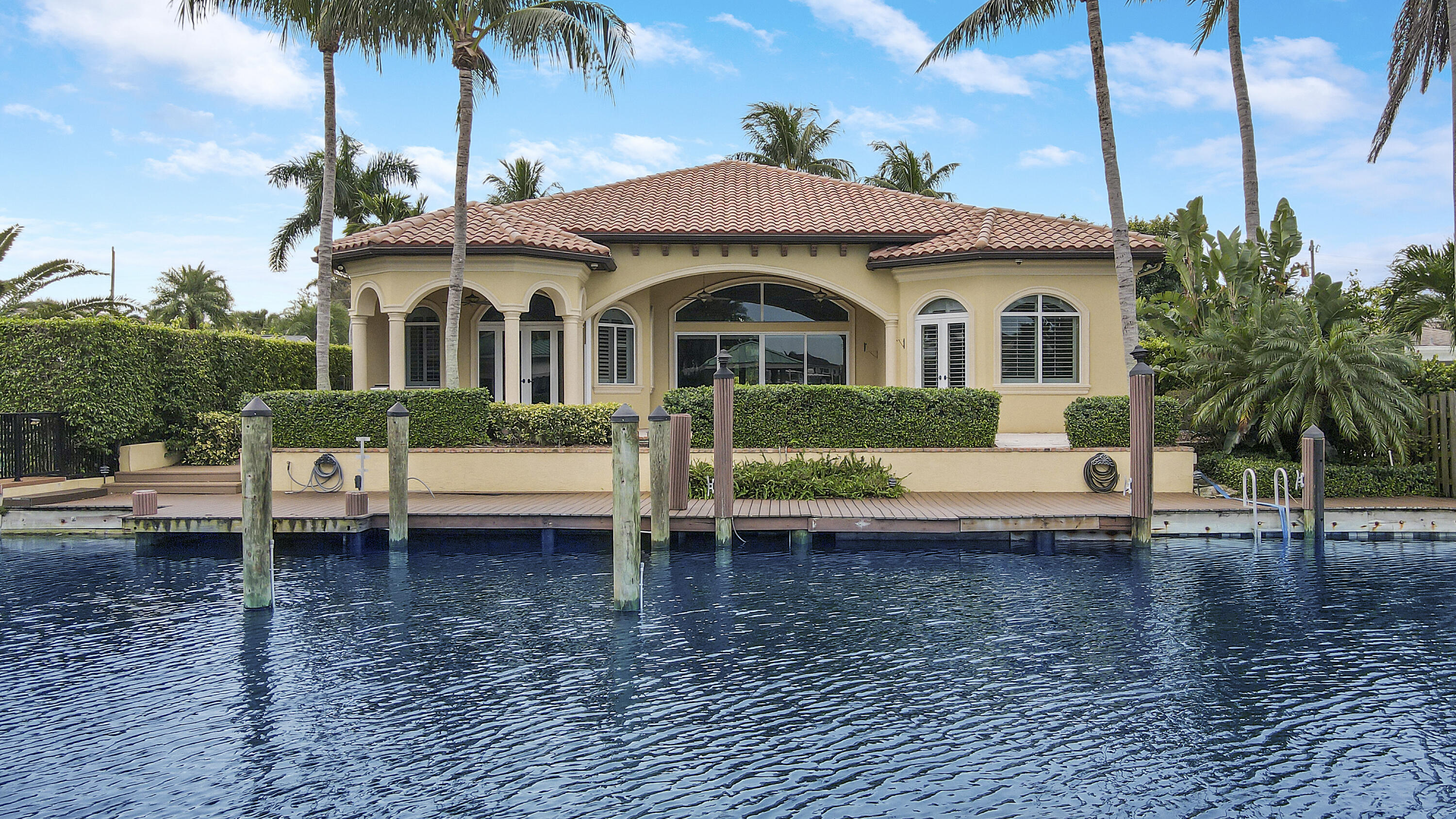 Offering over 4700 sq ft of indoor/outdoor living space, this WATERFRONT single family gem is sure to check all the boxes!  Situated on an oversized canal lot with intracoastal & ocean access. this centrally located 3 bedroom + office, 3.5 bath home offers upgrades galore! The freshly painted interior is highlighted by marble& wood flooring, plantation shutters, interior wet bar with icemaker & wine chiller, top of the line appliances, California Closets, dual a/c  architecturally pleasing features like 10' arched interior doors & extra wide baseboards.   Florida living at it's finest with  75' of maintenance free dock, gas heated pool, summer kitchen, outdoor shower, A/C   garage with tiled floor.  CBS construction, barrel tile roof, full impact windows, whole house generator completes this perfect tropical sanctuary.  See it today!