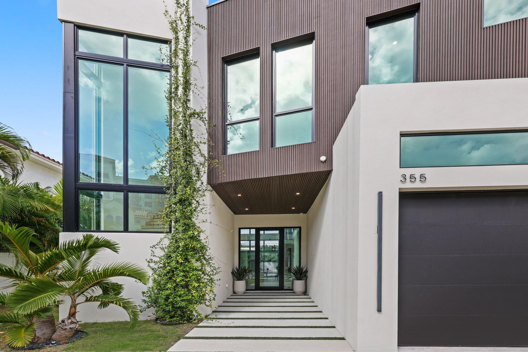 This exceptional and brilliant home is the creation of Nuvision Developments. Located steps away from Mizner Park, it features 5 bedrooms, 5 ensuite bathrooms and two half baths. 
The exterior has alluring curb appeal featuring Louvered Brazilian lumber and remarkable windows that frame a breathtaking, floating European oak cantilevered staircase. As you enter, your eyes are immediately drawn to a wall of floor-to-ceiling glass, overlooking the yard complete with a summer kitchen, pool, and hot tub.
The main living area boasts a lofty 23'8'' ceiling height, complemented by sleek matte Italian porcelain flooring. The kitchen is a haven for any culinary enthusiast, showcasing a colossal quartzite island, Wolf range, coffeemaker speed oven, Subzero fridge and wine fridge. There is also an expansive butler pantry. The powder room is a conversation piece with its stunning quartz integrated sink, cutting edge knobs and textured wall tile.
The primary bedroom resides on the main floor offering a serene view of the yard. The primary bathroom is a true masterpiece, featuring two vanities, three large LED mirrors, and exquisite Pompei Quartz Thazos countertops. 
Step outside to the yard and you'll find yourself in a contemporary resort like oasis with a saltwater pool and hot tub. The summer kitchen is perfect for entertaining family and friends. It contains a convenient cabana bath and outdoor shower.
European oak flooring sets the stage on the second floor. Each of the four bedrooms on the upper floor is a dream, with en-suite bathrooms featuring frameless glass showers and a captivating mix of textured and matte porcelain tiling. The VIP suite offers beautiful views of the summer kitchen and yard from its wraparound balcony. The office is a true retreat, offering an abundance of natural light through frosted glass double barn doors.
This remarkable home is conveniently located just steps away from the vibrant shopping and dining destinations of Mizner Park and the pristine beaches of Boca Raton. 355 is for the buyer who wishes to live in luxury and enjoy the very best that Boca Raton has to offer. 
Additional features: 
-Prewired low voltage for automated blinds in the main living area and primary bedroom
-Tankless water heaters
-Saltwater pool and hot tub