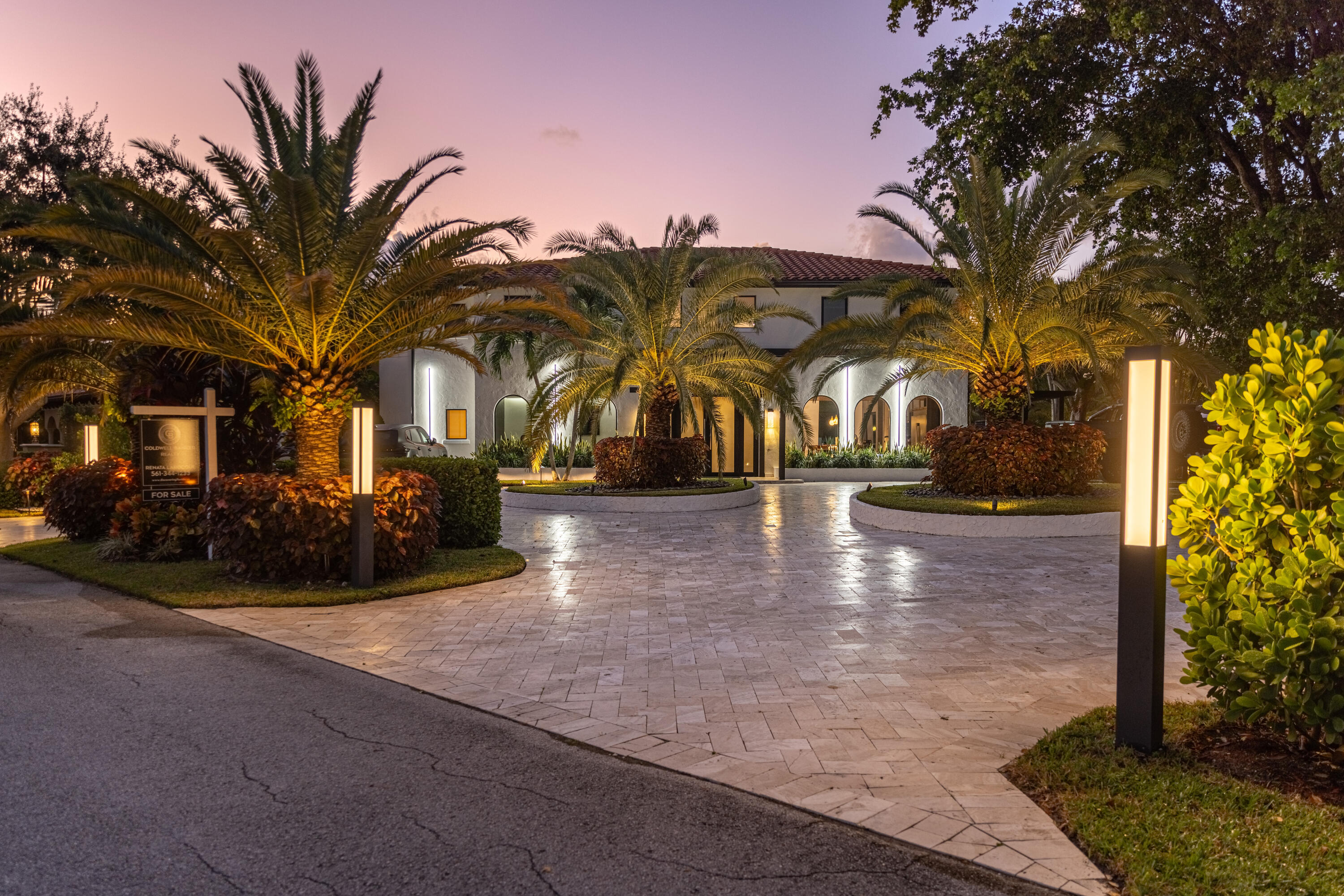 Magnificent Luxury, walk to Mizner! Pull up on the circular driveway with 7 parking spots to pure modern elegance in every thoughtfully updated detail. Meticulously landscaped with a custom aluminum portico, matching coded entry gates and wrap-around details. Inside find Ton-sur-ton wall tiles, custom stucco, and Wood Tile Flooring. Custom closets & solid wood doors throughout. The open kitchen stuns with a large Brazilian Granite island flanked with a Claro Walnut Slab for entertaining, Turkish Stone Pendants, Bosch appliances, Smart home, a comprehensive security system and Sonos sound. Offered furnished with superb BAER and Arhaus Furnishings, stately antique vases from Malta, custom aluminium outdoor furnishings and too many more upgrades to list! The ultimate must see! No HOA.  Enter to a custom-built closet for coats, hats, and keys. To the left, the office impresses with a glass swing door, vaulted LED-lit ceiling, and a built-in cooler with Brazilian granite. The open kitchen is a perfect for gathering around the large Granite island extended by a Claro Walnut 150 y/o polished slab to seat 8-10 people. Bosch appliances and Frigidaire double-door Refrigerator/Freezer, Charging ports and aluminum accents complete the space. The living area, furnished with Bear and Arhaus selections, includes a volcanic rock feature wall behind an 85" TV. Soaring 23-foot ceilings and wood tile floors enhance the room's open and airy feel. The entire home benefits from a smart 500-gallon water filtration system, keeping all water including that from the Smart Kohler toilet pure and clean. Reverse osmosis in the kitchen adds an extra layer of water purification. The main floor primary suite offers temperate comfort for bare feet on the 48x48 polished concrete tiles. The bedroom is centered around a king-sized bed on a natural sheepskin rug, with another 85" TV on the wall. The ensuite bath features a smart toilet, a separate polished concrete tub, and a matching sink on a Brazilian granite slab. The walk-in dressing room includes a washer/dryer, hand-wash sink, and glass door closets with interior lighting to keep your wardrobe and shoes fresh, dust free and easy to find. Take the polished concrete stairs with linear lighting to the second floor and find three additional bedrooms, two of which are en-suite, all equipped with Hunter Douglas window treatments. A second laundry room is located upstairs for added convenience. The entire home is powered by a comprehensive smart home system, including Sonos audio throughout, security cameras, and lighting controls, all accessible from your phone wherever you are. Outdoor Features: -Circular Driveway plus 7 car parking out front (PLUS garage/guesthouse in rear). -Outdoor vertical linear lighting, custom aluminum portico, matching wrap-around detail and side gates with coded entry. -A side yard with spice and wildflower nursery. -Anterior outdoor kitchen with a wood-fired oven and charcoal stove, and a tranquil Koi pond set within a Japanese garden. -Car charging Station -Vertical outdoor lighting -Circular Driveway with 7+ Parking spots Center courtyard Flanked by two Trex patios: -One side offers a custom aluminum double chaise lounge, -Other side features an outdoor kitchen equipped with; -EVO griddle, -Gas BBQ, -Double fridge, -Quartzite countertops, -Reclaimed wood beams. -A BAER diner table and hammock. 2nd side Yard: -A calisthenics park. Garage/former Guest House: -Full Cabana bath -Garage/gym with polished concrete floors, smart garage doors, 13.5ft ceilings, and neon LED lighting separate AC. -Half-century-old bonsai tree.