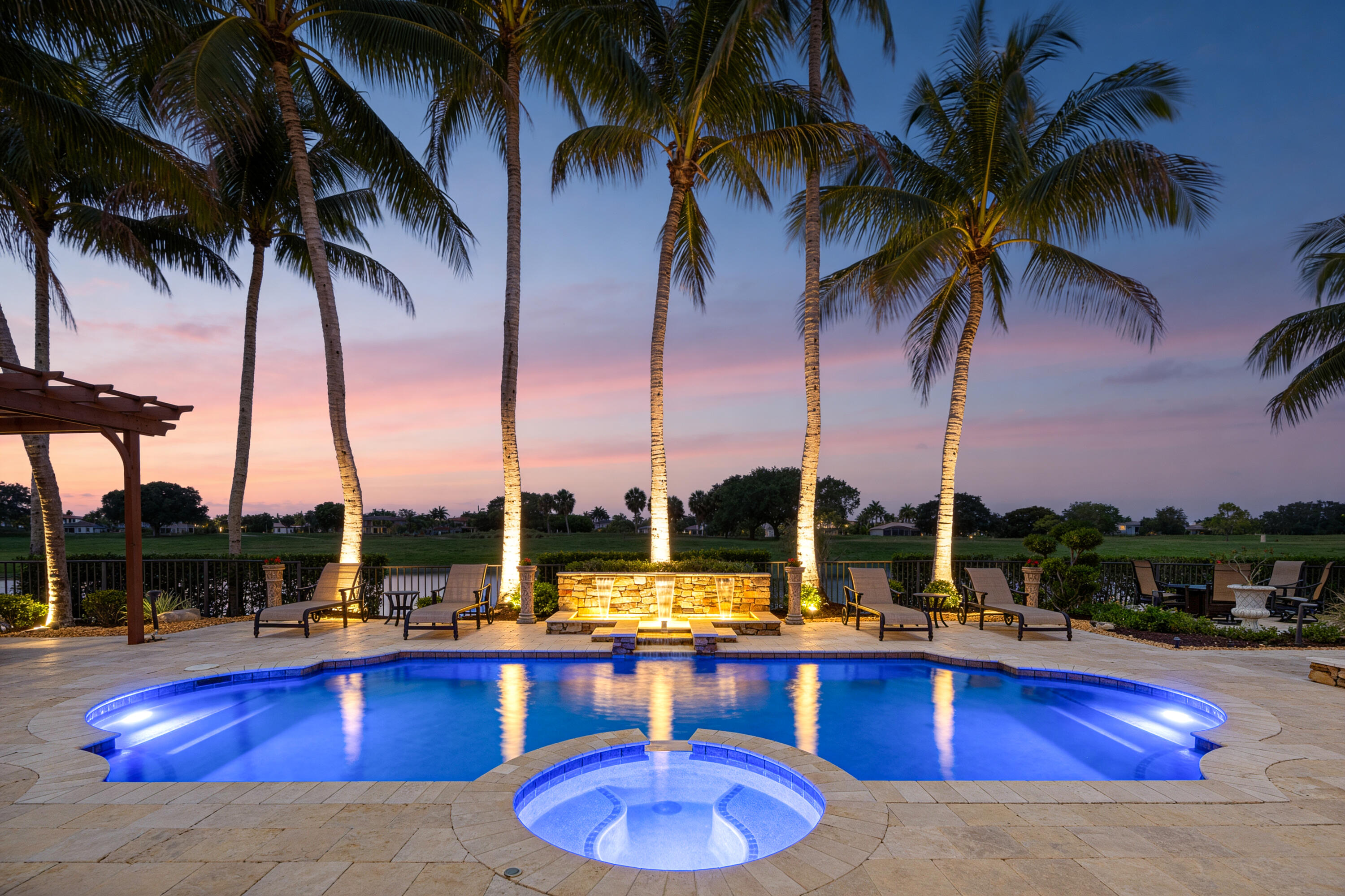 ABSOLUTELY STUNNING WATERFRONT ESTATE in prestigious gated Heron Bay! Overlooking a private nature preserve, this elegant 2-story Mediterranean-inspired home offers 4,506+ SF with 8 bedrooms, a theater room, a home office, dramatic volume ceilings, and floor-to-ceiling windows. Gourmet chef's kitchen features granite countertops, oversized island/bar, and wine cooler. Luxurious 1st-floor primary suite includes tray ceilings and spa-like bath with dual vanities, oversized shower, and Jacuzzi tub. Tropical resort-style backyard with heated pool/spa, waterfall, pergola, summer kitchen, bar, covered patio, lush landscaping, accent lighting, 3-car garage, and paver driveway. Top-rated schools & luxury amenities!