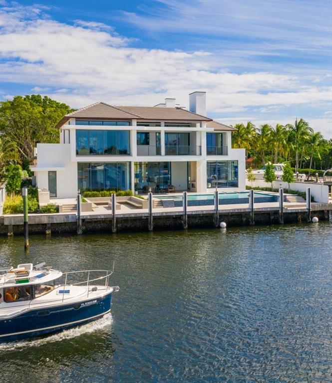 Most recently completed new construction in Harbor Beach! Beautifully refined Coastal Modern design by Randy Stofft/Builder Sarkela Corp. Incredible wide & picturesque Lake Sylvan (open to intracoastal) & Marina views from large corner property. Stunningly open & light floorplan, walls of windows that fold back completely for outdoor enjoyment & entertaining. An expansive covered loggia, & multiple loggias/balconies include a roof top terrace. Chef's kitchen opens to breakfast area & family room, wine wall, two sided fireplace. Glass enclosed library/den opens to club room & bar. One bedroom suite downstairs, incredible Master with private balcony & separate bathrooms/closets. All bedroom suites large & custom designed. Spectacular custom pool & fire pit. Private Surf Club across A1A