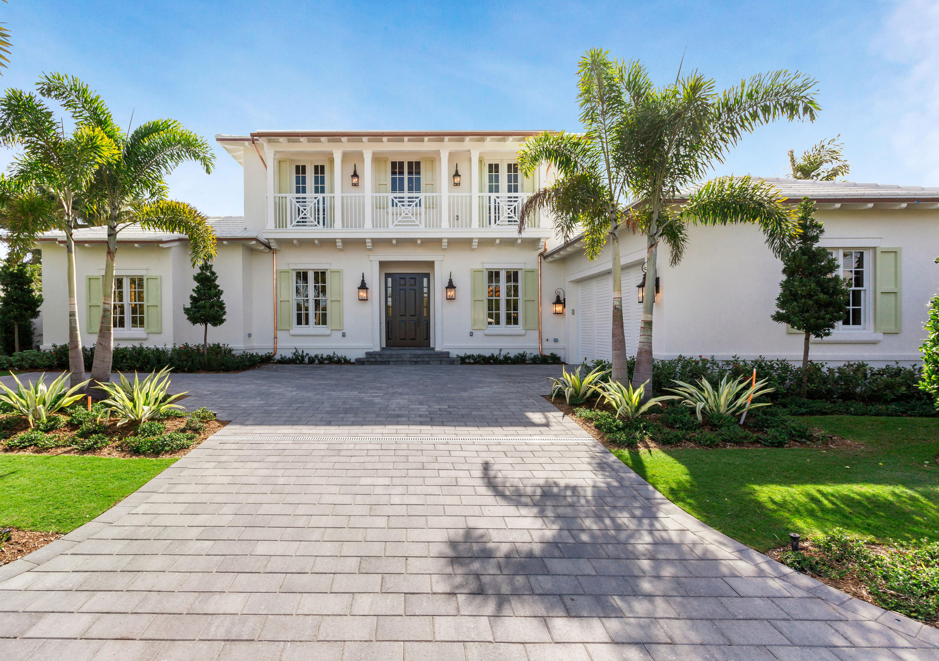 This elegant, newly constructed home was built by Courchene Development and completed in 2019. The residence is situated on a large lot, offering over 4,900 total square feet, with 4 bedrooms, 4 full baths and 2 half baths. The home's open floor plan lends itself to entertaining, both indoors and out, with French doors opening to the outdoor loggia, which has a built-in barbeque, pool, spa and outdoor shower. The solid mahogany front door leads you into the foyer complete with an elevator, powder room, and staircase to the second floor. The dining room is open to the foyer and the living room for easy entertaining and features beautiful moldings, high ceilings, and windows looking out to the front entry. The living room has a custom built-in cabinet for a media center or to

and/or books as well as a wet bar with an undercounter refrigerator and ice maker with cabinets above. In addition to the dining room, there is a breakfast area overlooking the pool. The kitchen offers top-of-the-line appliances with a six-burner Wolf range, a Thermador refrigerator and freezer, a large Thermador wine cooler, natural stone Quartzite countertops, and ample storage.

The gracious ground floor master suite has wide plank oak floors, large windows looking out to the garden and pool, two walk-in closets, a luxurious bathroom with a separate soaking tub and shower, two water closets, dual sinks, and vanity.

The library serves as a wonderful media area and/or office, conveniently located off of the kitchen/living room. A custom built-in cabinet warms up the room and adds extra storage and desk space. Three guest bedrooms are located on the second floor with wide plank oak floors, en-suite bathrooms, walk-in closets, and French doors that open onto private balconies.

The pool terrace, with beautiful limestone pavers, offers ample space for lounging and entertaining. Enjoy sitting under the covered loggia complete with built-in grill for al fresco dining. The spa and fountain feature flow into the pool making this a relaxing retreat.

Additional interior features include:
-Italian white marble flooring throughout the main
living areas
-Custom Crestron automation system with built-in
speakers and lighting
-Central vacuum system
-2-car garage
-Hurricane impact windows and doors
-Generator-ready poured slab and wiring.
-Lot Size: 100' x 115' approximately
-Ideally located one block from the beach and Lake
Trail. And only a short distance to restaurants, and
shopping