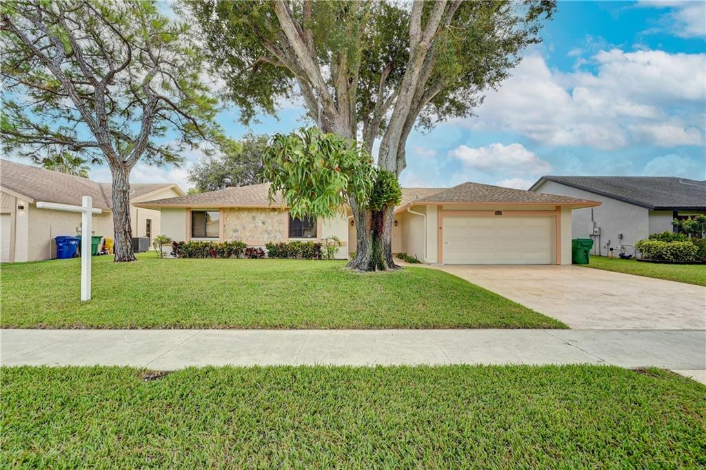 This Immaculate 4 Bedroom/2.5 Bath Home sits on a Water View Lot has a lot to offer. This home has been well maintained with the mature trees and beautiful large Orchids. Perfect home for a growing family with lots of living space including separate Living Room, Dining Room, Family Room, Kitchen with Bar Counter Eating & separate Breakfast Area.  Kitchen features Wood Cabinets, Quartz Counters tops, matching Appliances with Counter-Depth Refrigerator and lots of extra storage space. Spacious Bedrooms and Bathrooms. Full Sized Washer & Dryer & Laundry Room. Oversized Covered Screened Porch - great for entertaining all year around. Solar Panels System with 24 Panels reduces Home Energy Cost, Solar Powered Water Heater, Roofs replaced in 2018, A/C 2011, Hurricane Protection, Security System.