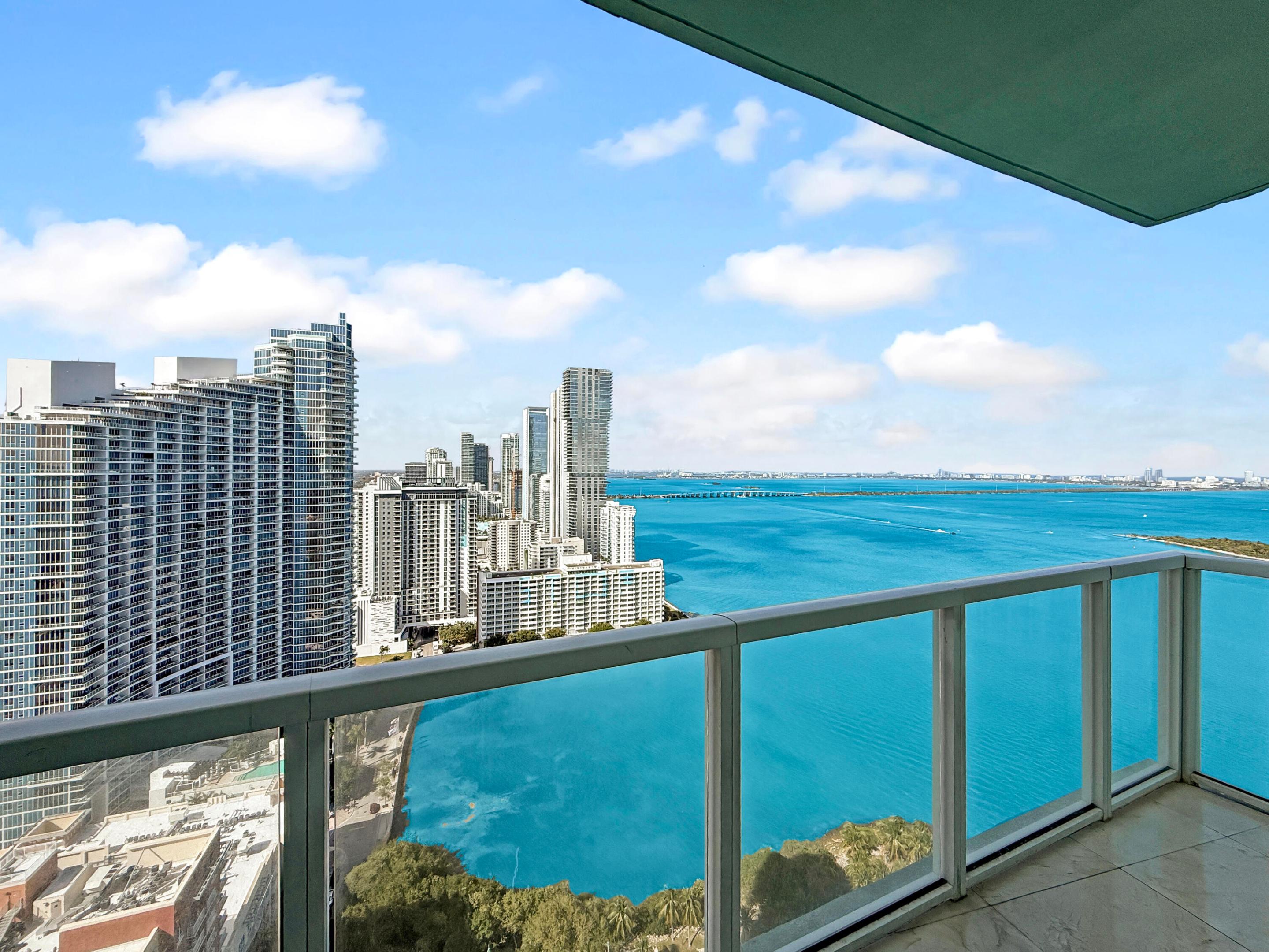 Luxury living at Quantum on the Bay. Welcome home to this elegant 2BR/2BA residence with over 1230 sq ft of split floor plan living space. Offering stunning ocean and city views, floor-to-ceiling impact windows, and a spacious private balcony. Features include marble floors, a modern chef's kitchen with island, in-unit laundry room, and 2 walk-in closets. Both baths have stone countertops, rich wood cabinetry, and shower/tub combos with glass doors. Enjoy the best of resort-style amenities: pool, spa, sauna, 2-story fitness center, billiards, workspace, entertaining area, and much more, plus assigned, garage parking, and valet, guest parking. Water, basic cable and internet included. Renters insurance is required.