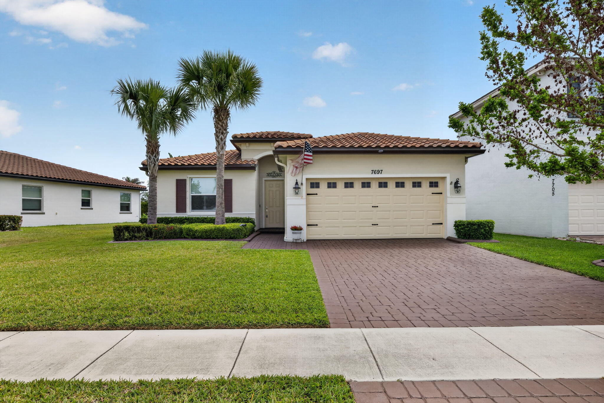 Welcome to this beautifully maintained Lennar home located in the highly desirable Copper Creek community of Port St. Lucie. This inviting residence offers a modern, open-concept layout designed for effortless living and entertaining. The spacious interiors are flooded with natural light and accented by premium upgraded Bali shades and custom window treatments throughout the entire home. The heart of the home is a well-appointed kitchen with ample cabinetry that flows seamlessly into the living and dining areas. The generously sized bedrooms provide comfortable retreats, while the primary suite offers a private sanctuary with its own en-suite bathroom and walk-in closet. Ceiling fans are installed throughout the home to keep the space cool and comfortable year-round. Exceptional Outdoor Living & Upgrades Step outside to your screened-in rear patio and enjoy a backyard oasis featuring lush tropical landscaping in both the front and back. The exterior is meticulously maintained by a built-in Rainbird auto-sprinkler system, while professional rain gutters with underground drains ensure the yard remains pristine and dry. Best of all, you can enjoy incredible backyard views of rocket launches from the Kennedy Space Center! Key Features & Added Value: Power Security: Includes a Yamaha generator with all accessories for peace of mind. Enhanced Entry: Features a hideaway enclosed screen door on the front entrance. Added Storage: Convenient fold-up stairs lead to a spacious attic storage area in the garage. Lennar Community Perks: Enjoy access to Copper Creek's premier amenities and a location near top-tier shopping, dining, and parks. This home offers the perfect blend of modern comfort and thoughtful high-end upgrades—don't miss your opportunity to make this unique Copper Creek property yours!