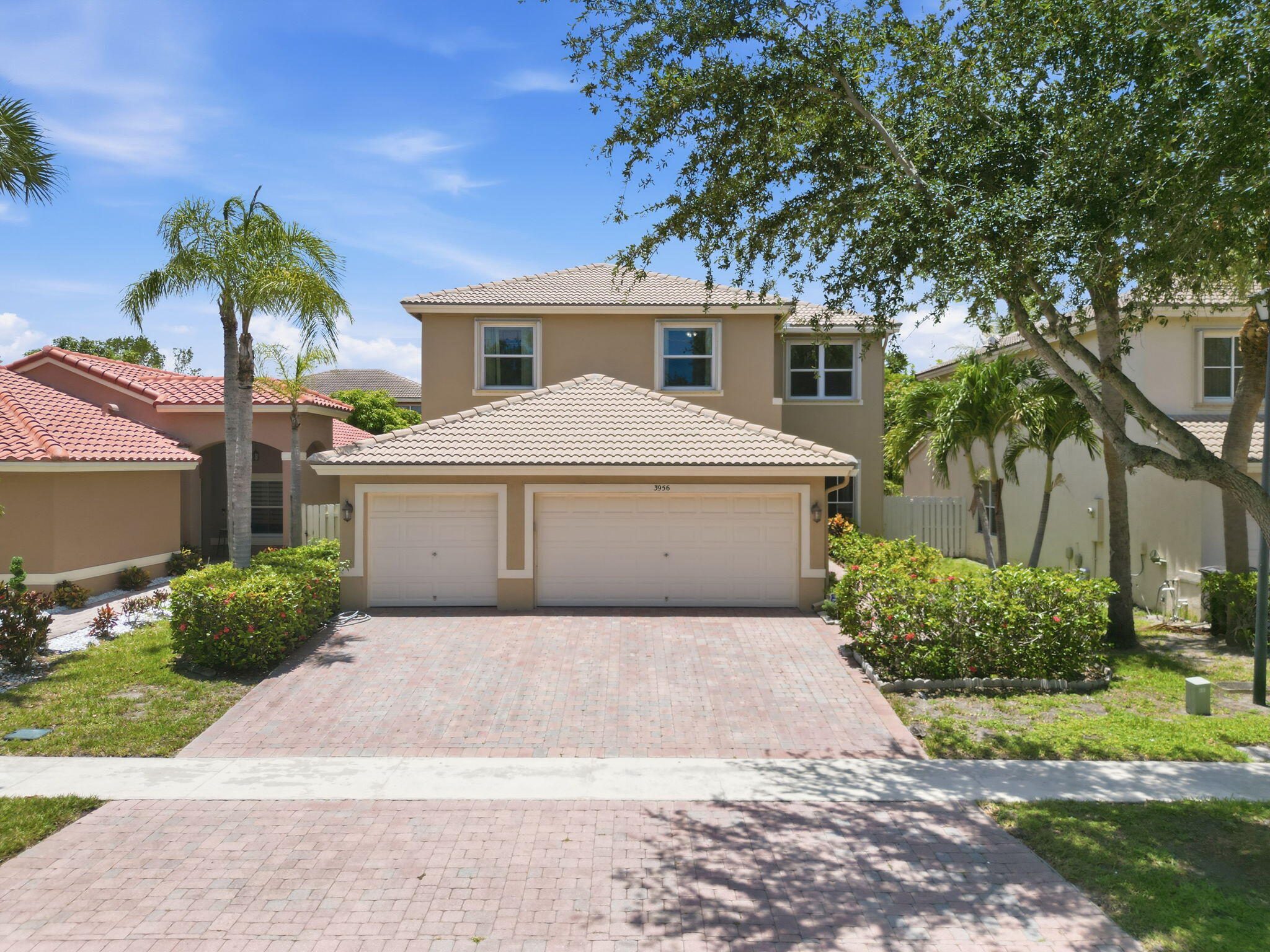 Incredible opportunity to own this spacious 5-bedroom, 3-bathroom home with a 3-car garage in the desirable Lakes of Laguna community. Offering plenty of room for family and guests, this home features beautiful wood flooring throughout the first floor and comfortable carpeting on the second level.  The well-appointed kitchen boasts 42-inch cabinets, providing abundant storage and workspace for the home chef. A first-floor bedroom and full bath offer the perfect setup for guests, extended family, or an elderly parent seeking convenience and privacy.  Step outside to a huge screened patio, ideal for relaxing, entertaining, or enjoying Florida's beautiful weather year-round. This home is ready for you to add your personal touches and make it your own.   Located within the gated community of Lakes of Laguna, residents enjoy security and a convenient location just minutes from downtown West Palm. Explore an array of fine dining, shopping, entertainment, and cultural attractions, including performances at the renowned Kravis Center for the Performing Arts.  Don't miss this exceptional opportunity to own  home that combines space, comfort and an outstandng location.