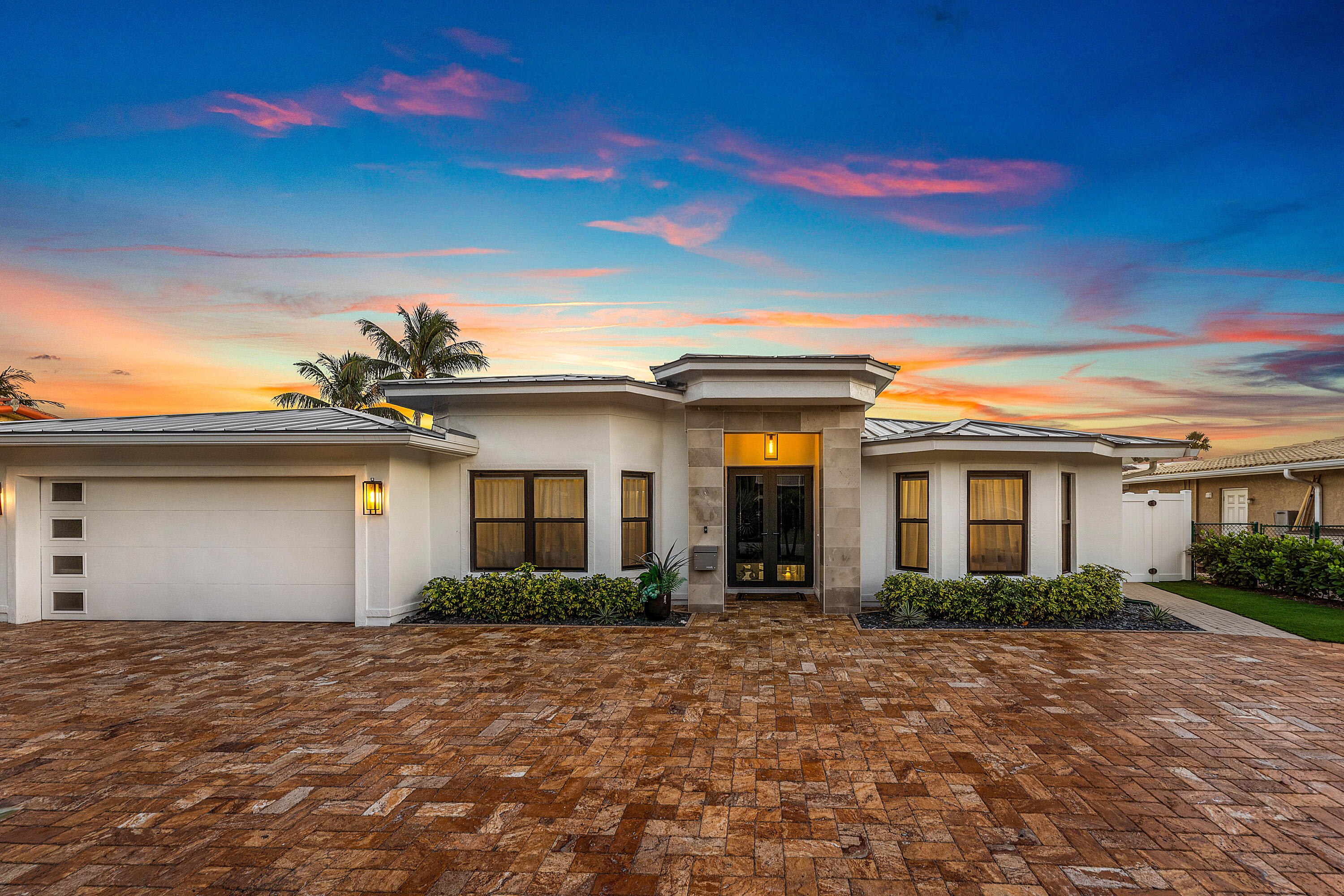 A fully reimagined home where modern design meets effortless waterfront living. Renovated from top to bottom in 2023, this property presents a true turnkey opportunity in one of East Boca's most desirable waterfront communities, Harbour East. Offering 80 feet of water frontage with a boat lift, no fixed bridges, direct ocean access and an exceptional setting for boating enthusiasts. Significant improvements add lasting value and peace of mind, including full impact windows and doors, a 2023 roof, a 2023 water heater, and a new electrical panel installed in 2026. The interior was completely updated with high quality finishes and meticulous attention to detail throughout. Each space reflects contemporary style balanced with everyday functionality, creating a seamless layout ideal for both comfortable living and entertaining. Outdoors, the backyard features newly installed turf, delivering a lush, low maintenance environment. Located just minutes from Boca Raton's beaches, parks, dining, and shopping, this is an exceptional opportunity to own a move in ready home in the heart of East Boca.